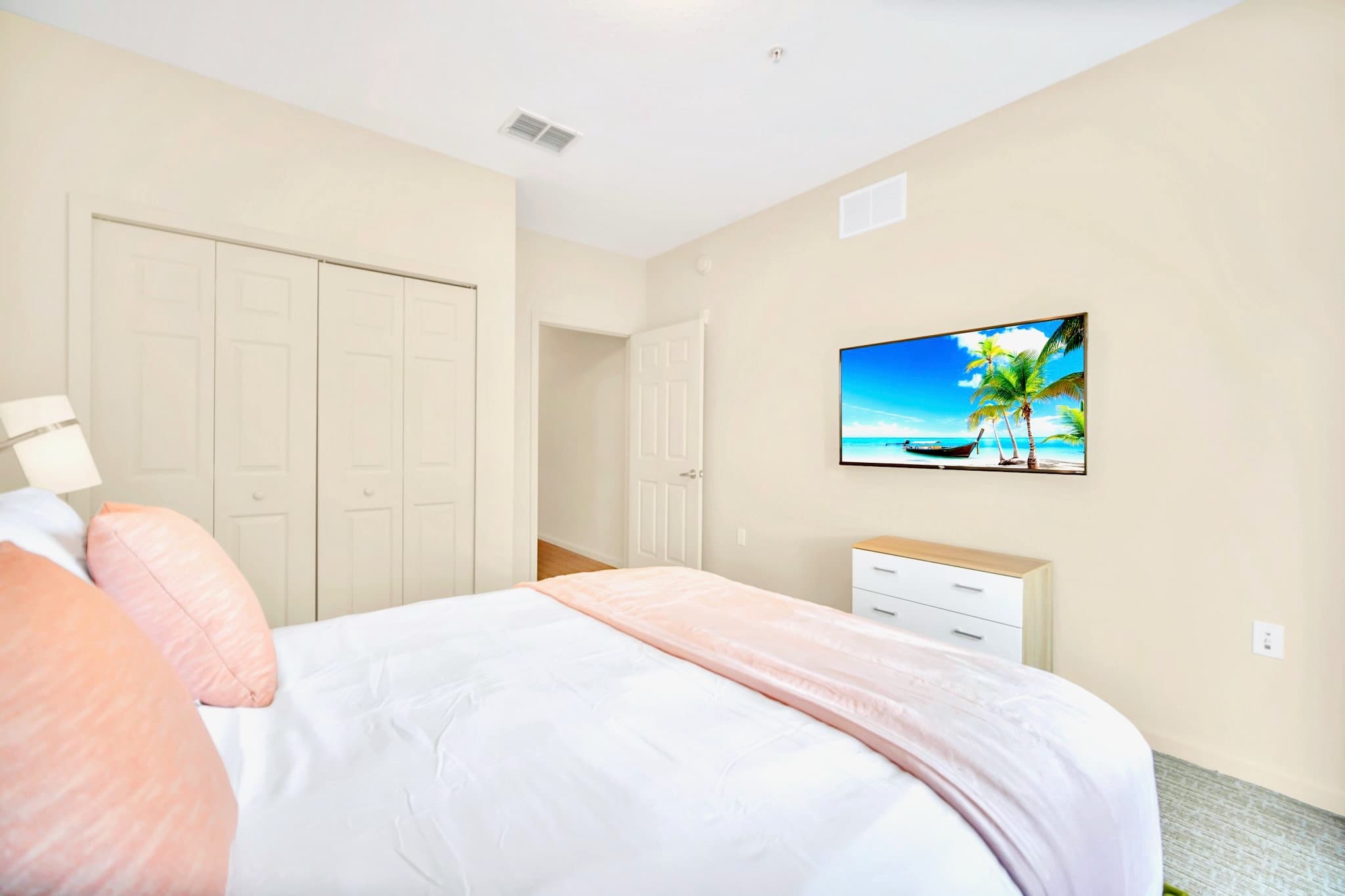 Vibrant Queen bedroom with smart TV 