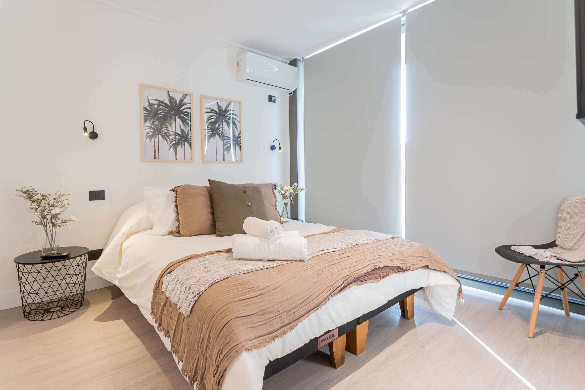 Relax in this stylish bedroom featuring cozy decor and natural light, perfect for unwinding after a day of adventure.