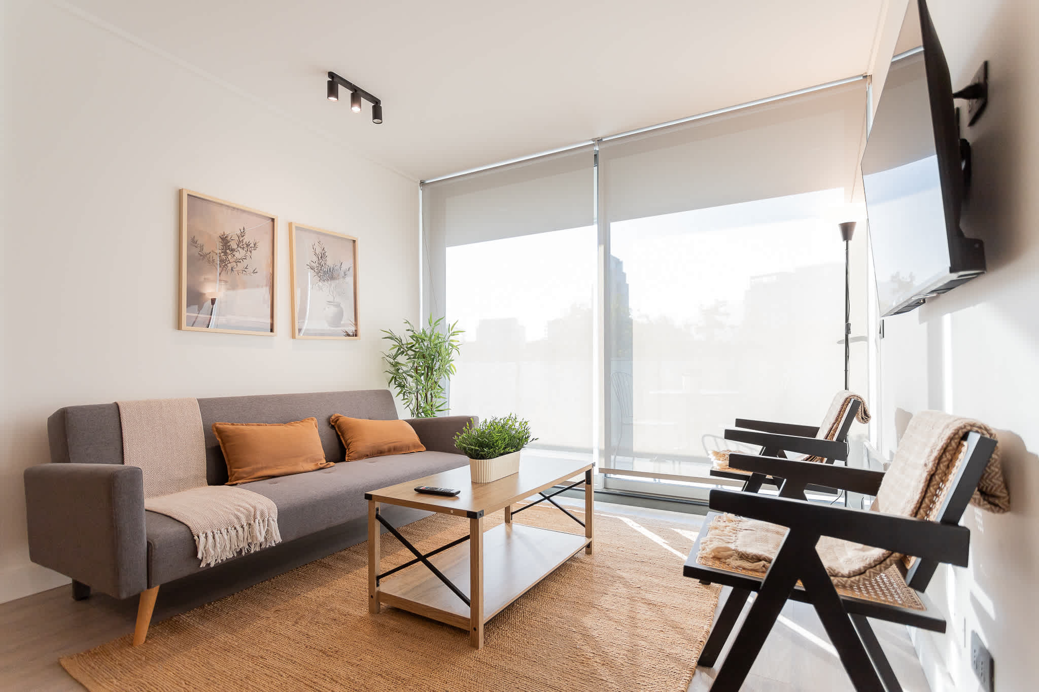 Bright and modern living room with stylish decor, perfect for relaxation and enjoying natural light.
