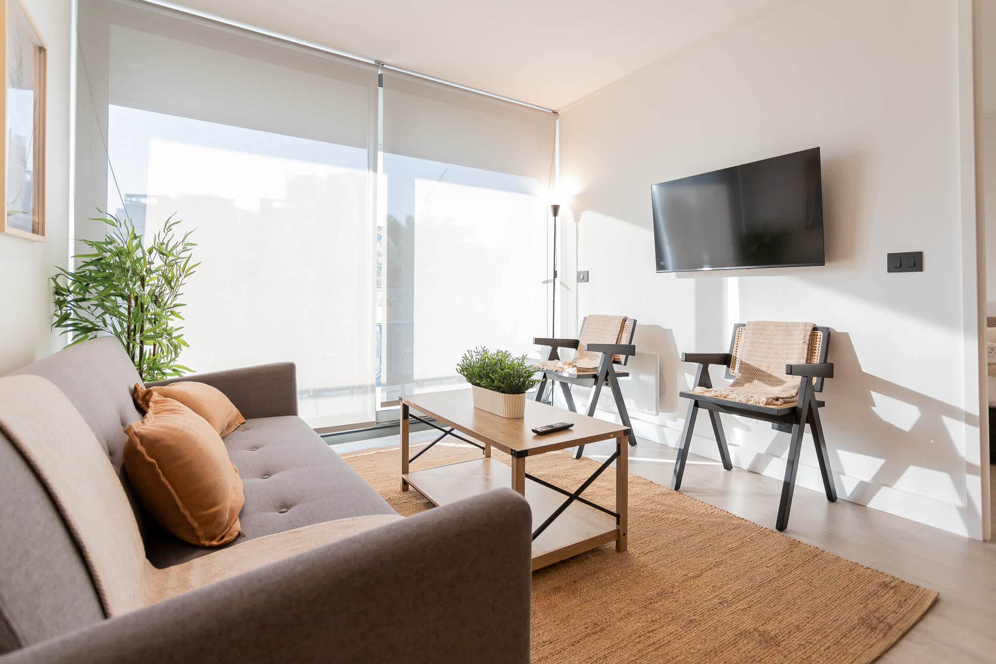 Bright and inviting living room with modern decor, perfect for relaxation after a day of exploring.