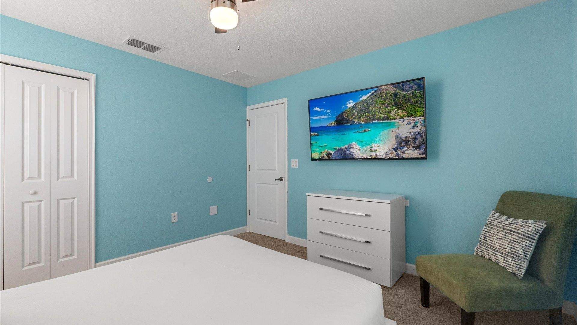 Vibrant queen bedroom suite with smart TV
