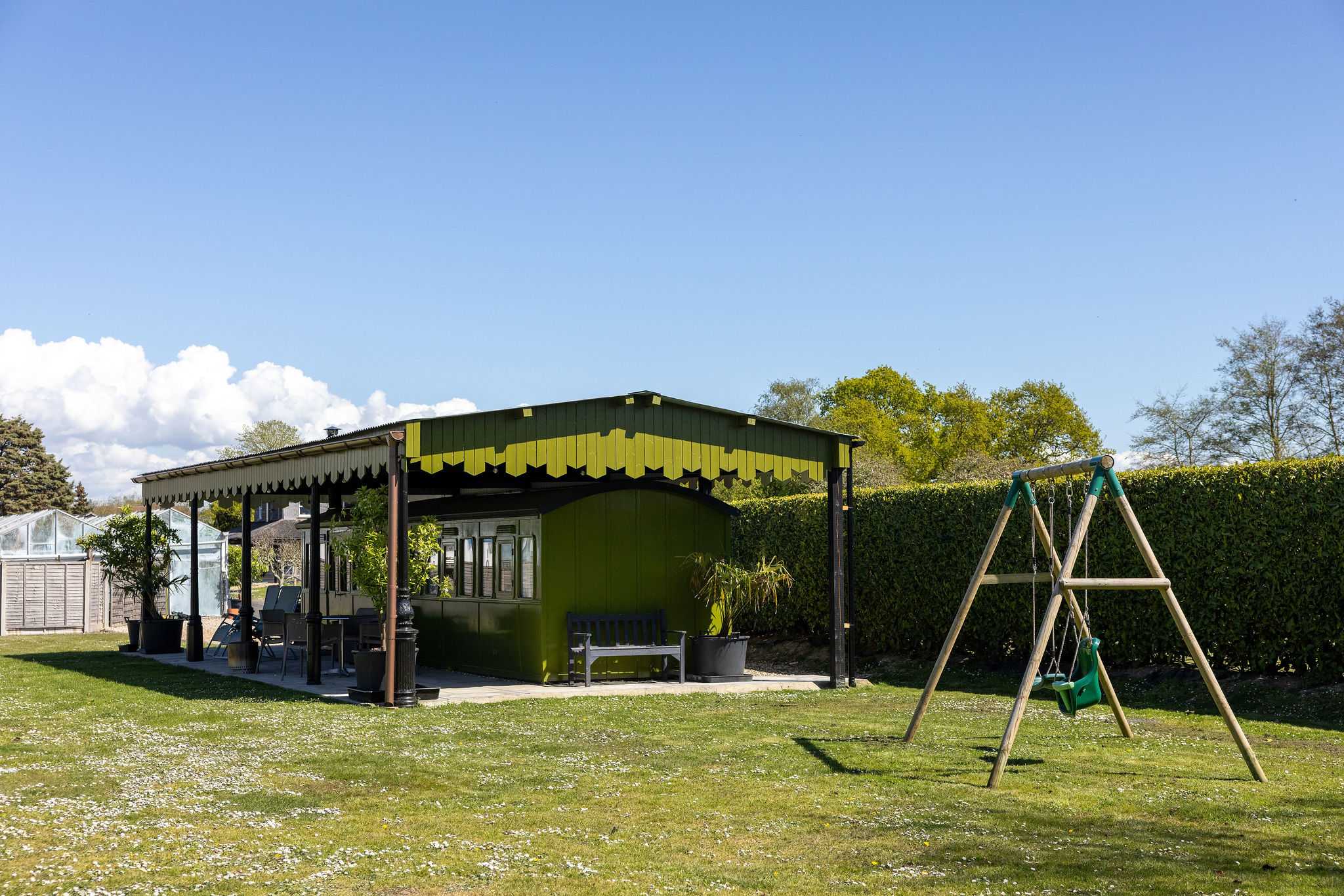 The carriage has a private outdoor space, with undercover patio, outdoor dining furniture, BBQ and swing set.