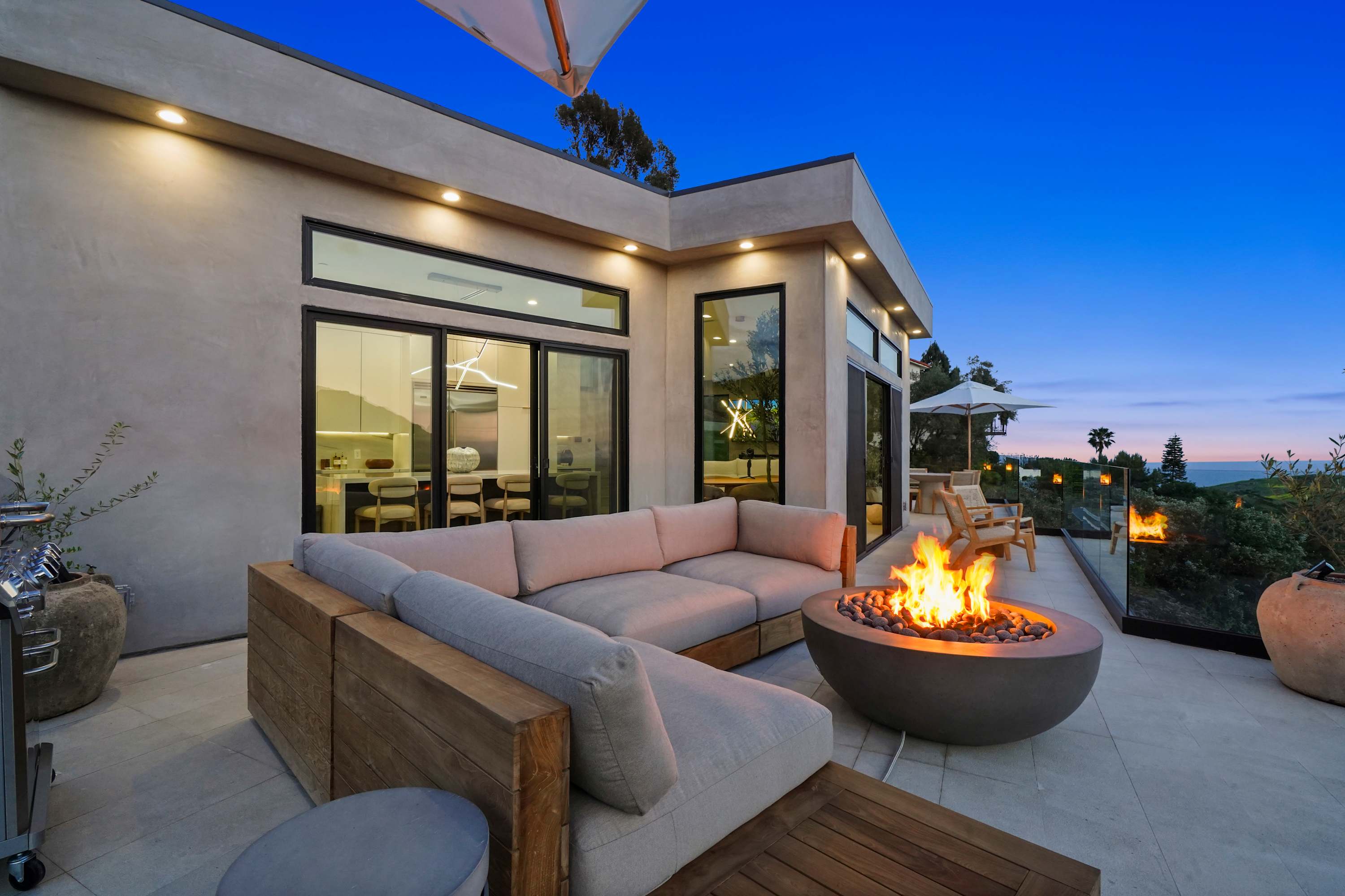 Outdoor lounge with built-in fire pit, perfect for evening gatherings.