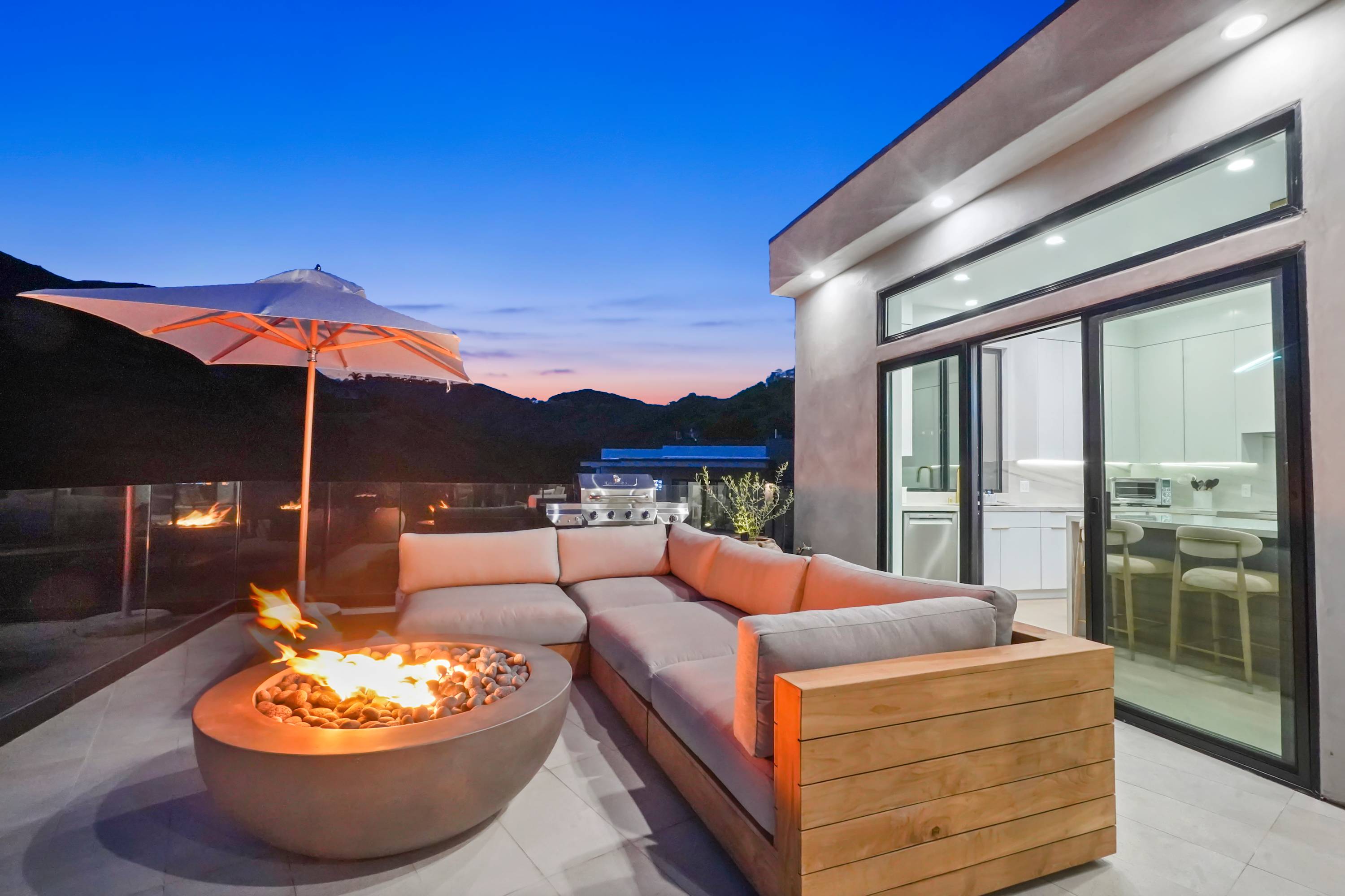 Cozy up around the fire with panoramic views of Malibu’s coastline and hills.