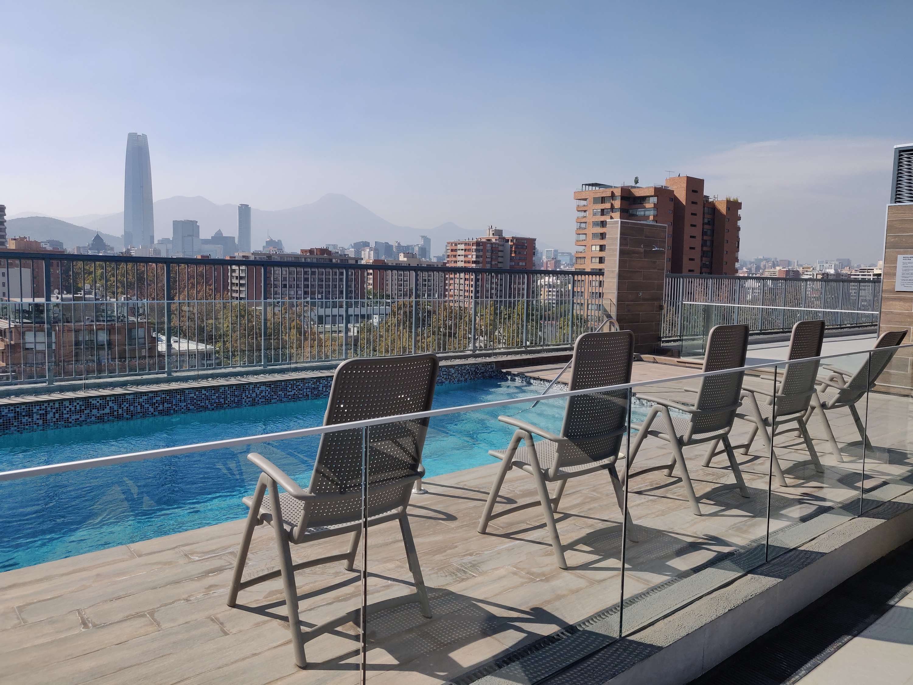 Relax by the rooftop pool with stunning city and mountain views—your perfect urban oasis awaits!