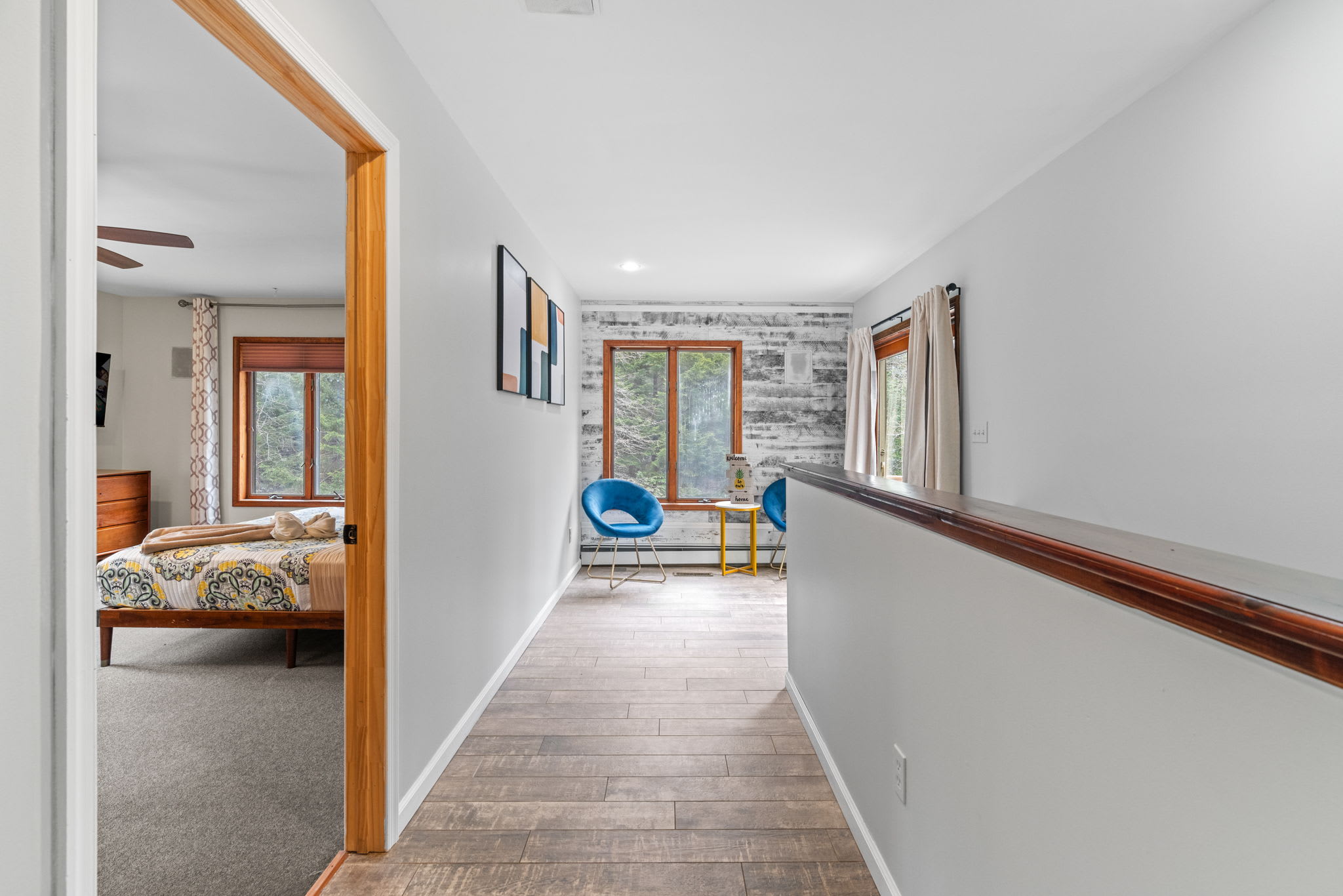 Upper Level Glow
This bright hallway leads you to peaceful bedrooms and a cozy lounge corner tucked at the end.