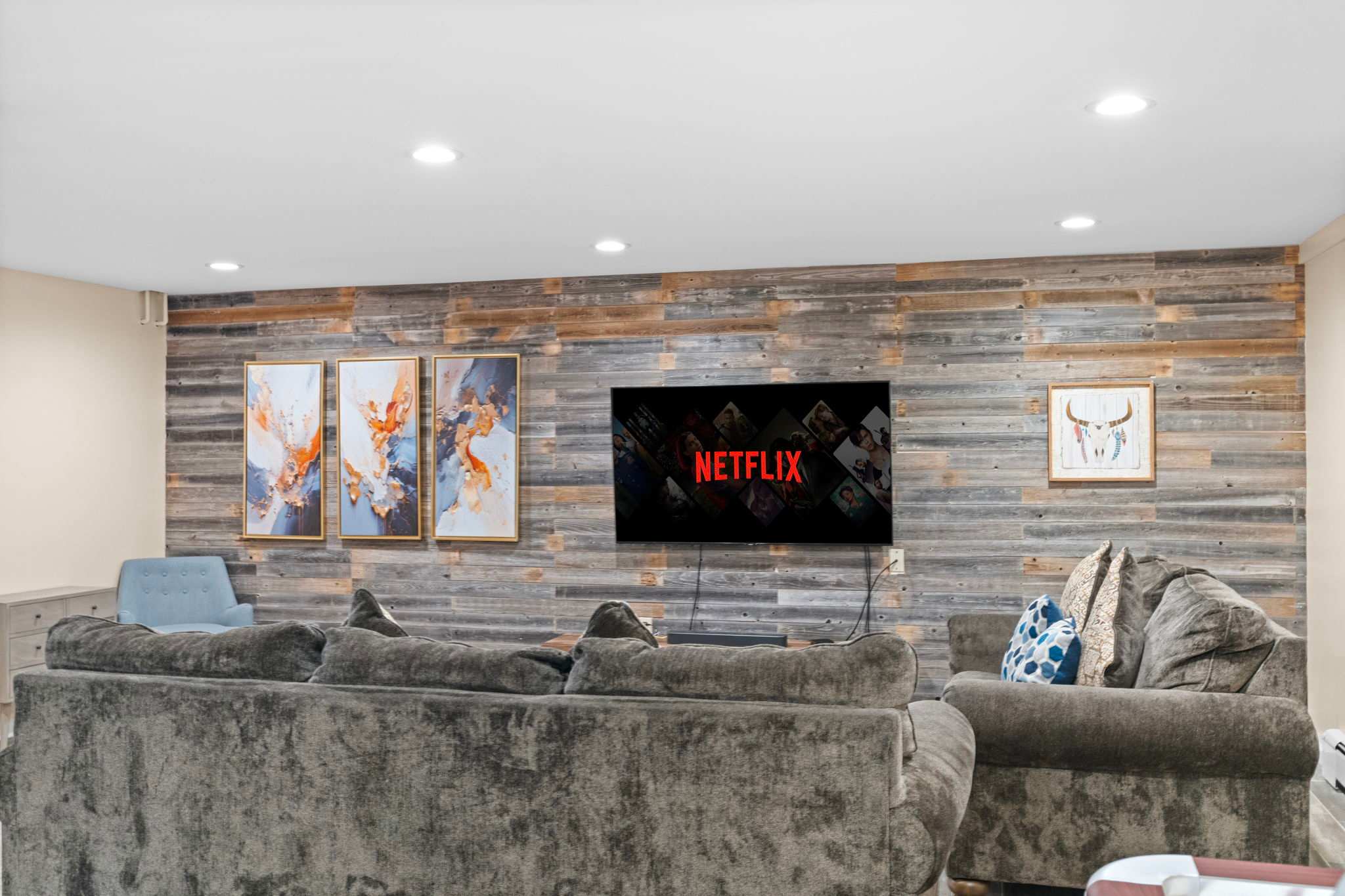 Ultimate Movie Lounge
Oversized couches, a giant TV, and rustic wall textures create a space built for epic movie marathons.