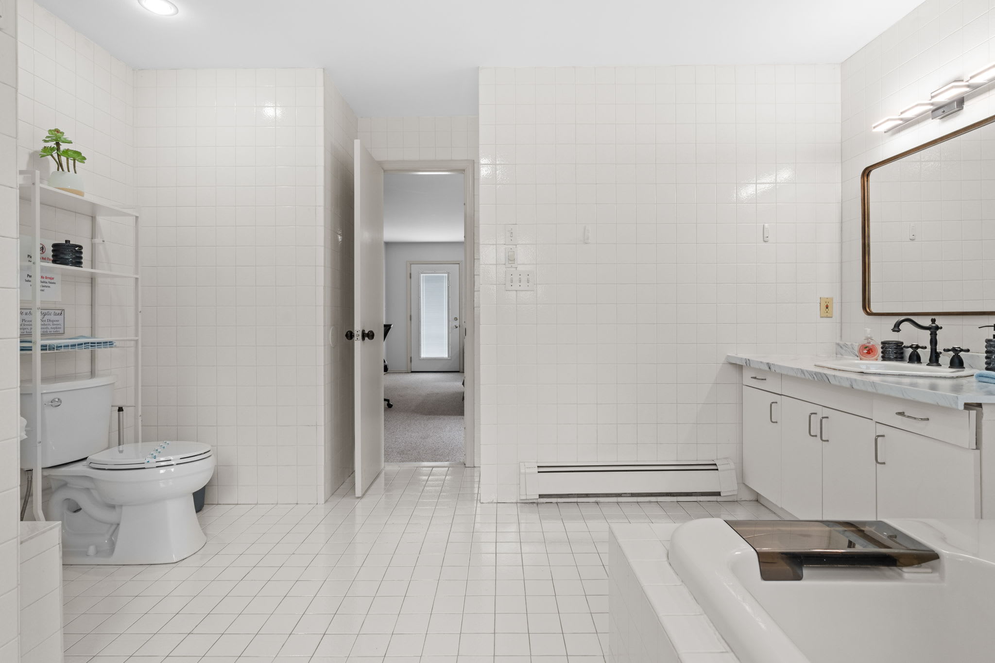 Full Suite Feel
A wide view of the bathroom layout featuring a soaking tub, full vanity, and plenty of space to move around.