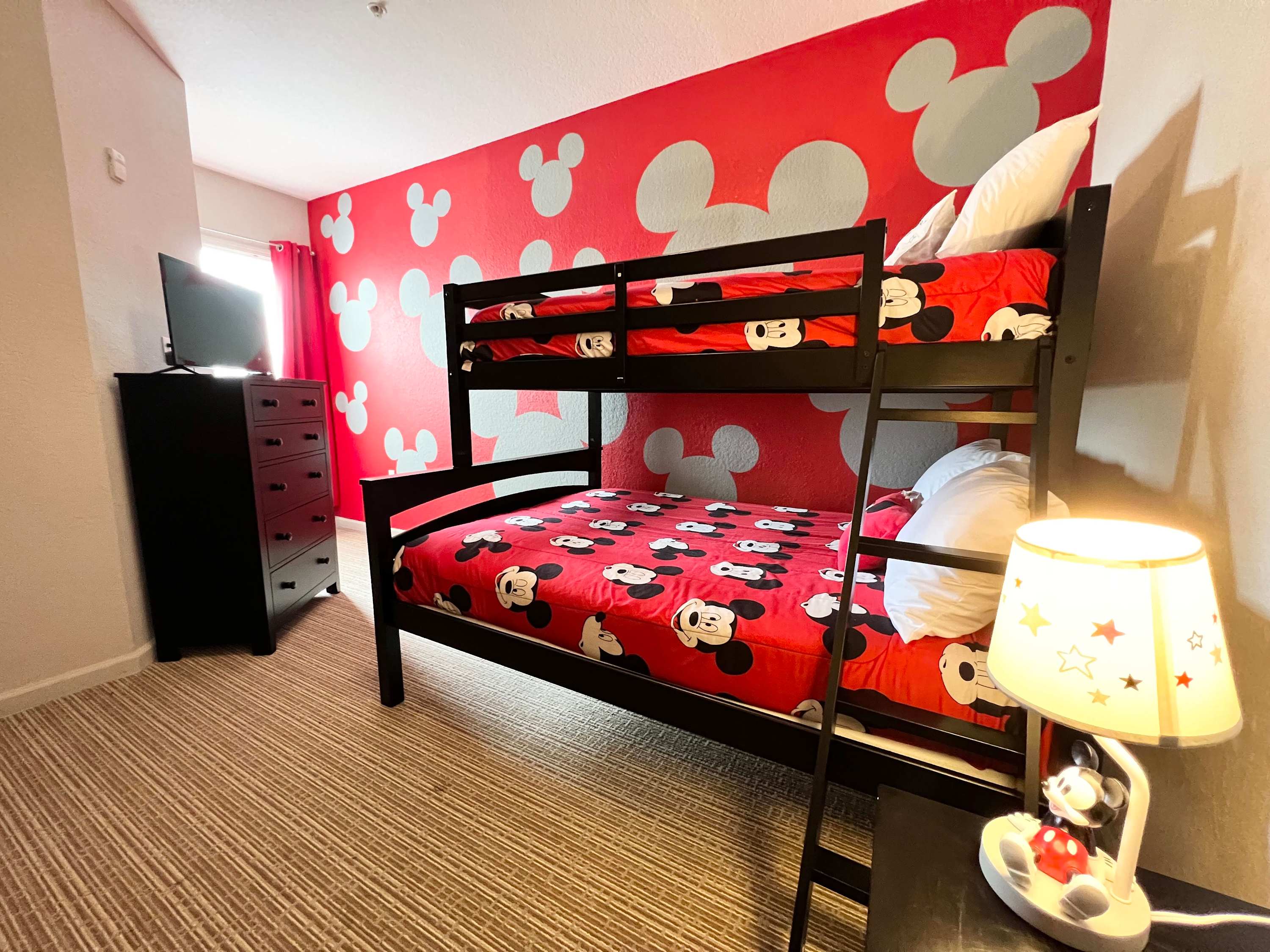 Fun Mickey Mouse-Themed Bedroom Featuring A Bunk Bed With Twin And Full Mattresses