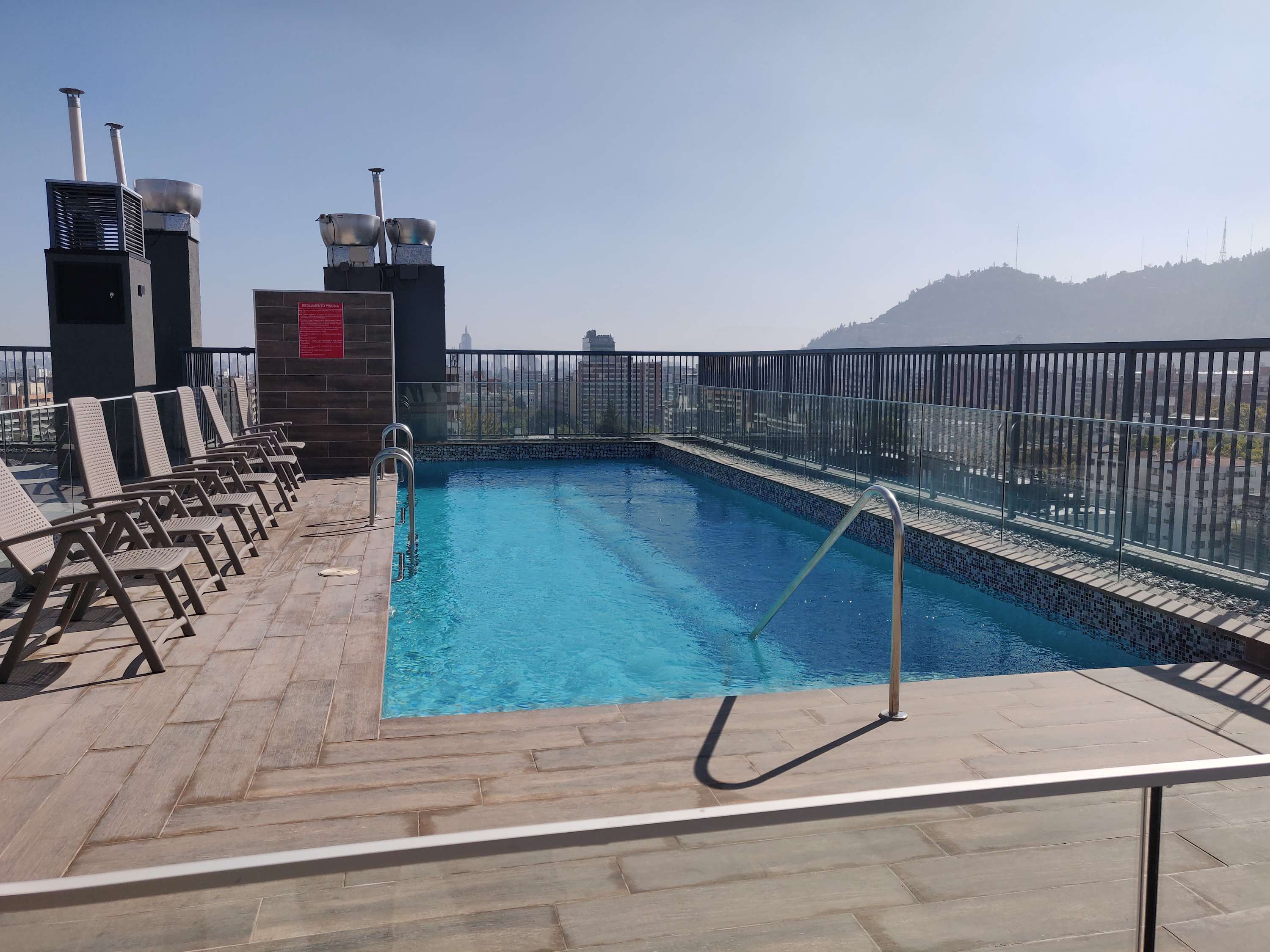 Relax by the rooftop pool with stunning city and mountain views, perfect for a refreshing dip or sunbathing in style.