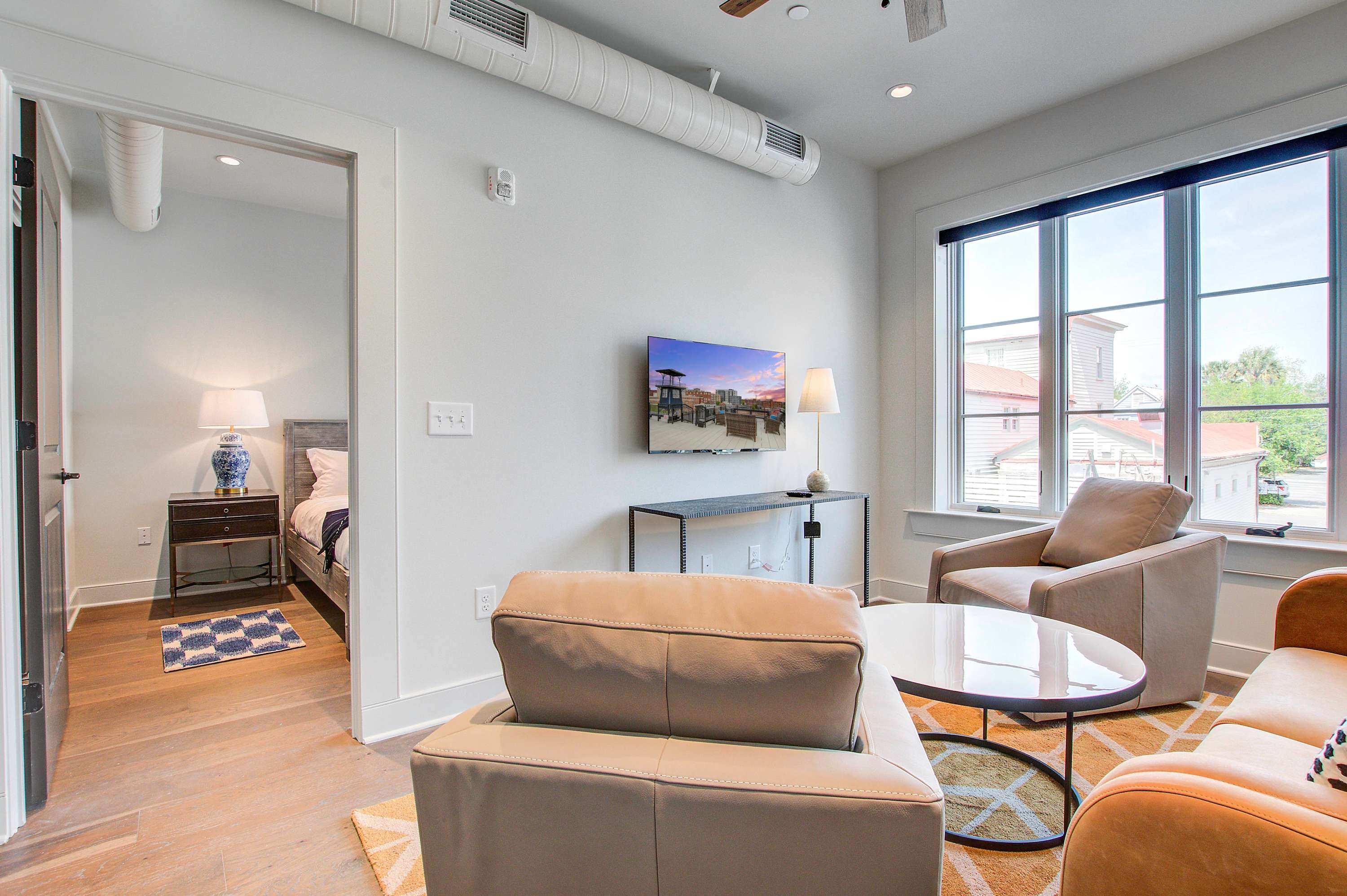 Professionally designed living room space with a Smart TV! Please note there is no balcony but plenty of shared outdoor seating space. 