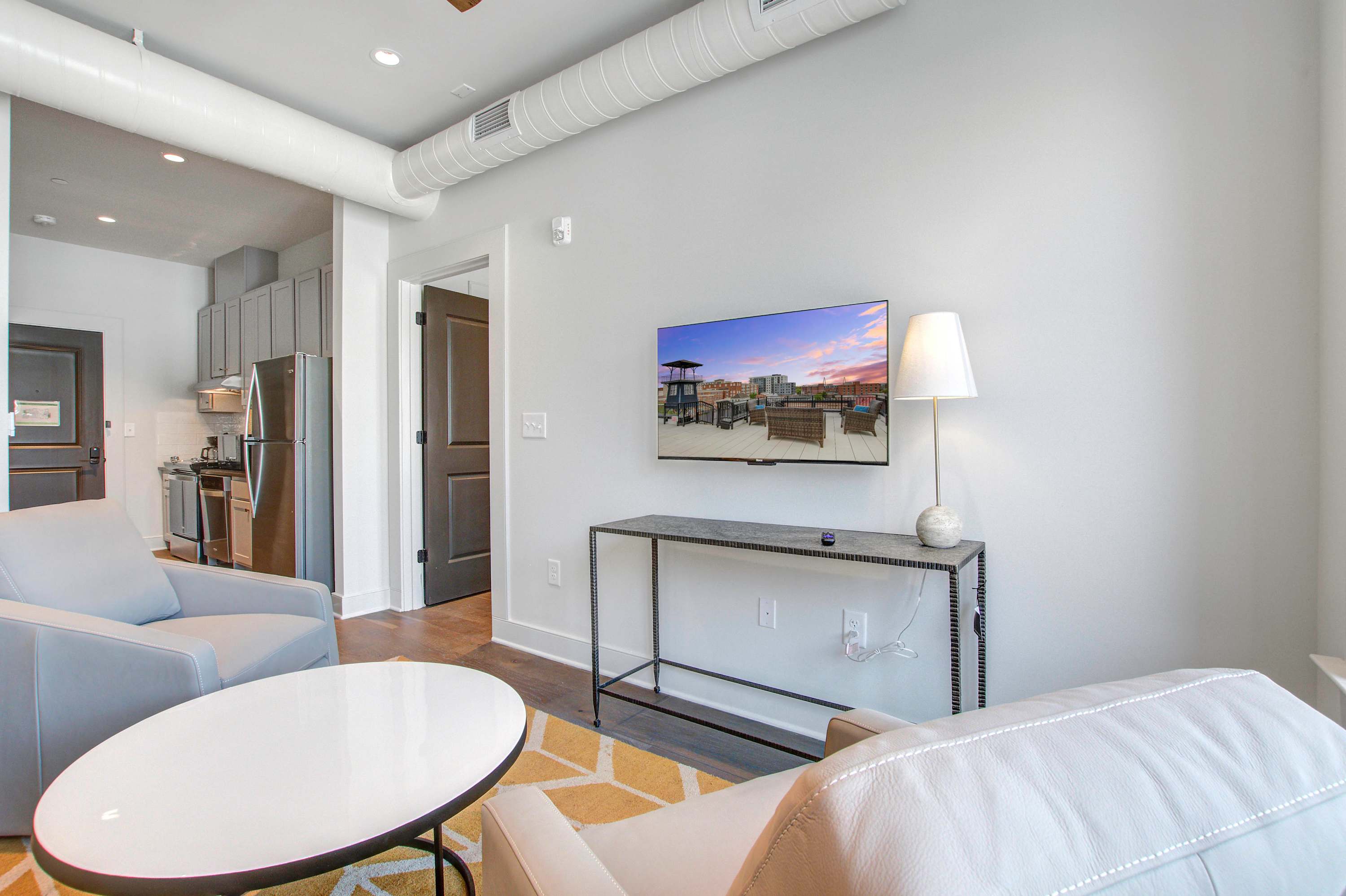 Professionally designed living room space with a Smart TV! Please note there is no balcony but plenty of shared outdoor seating space. 