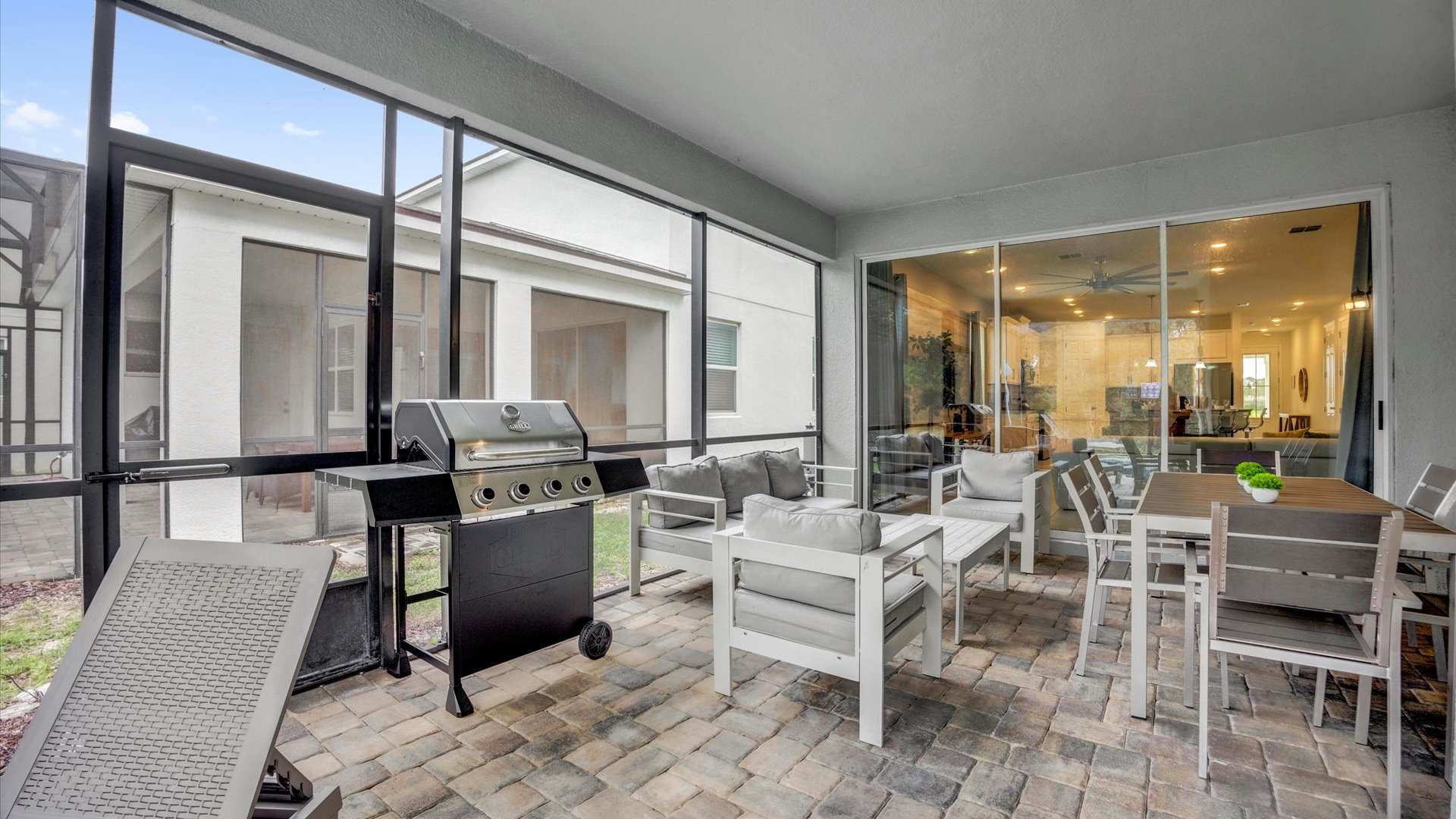 Outdoor patio with lounge and dining area and BBQ grill