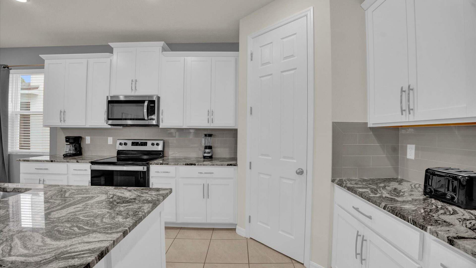 Spacious fully equipped kitchen with marble counter tops