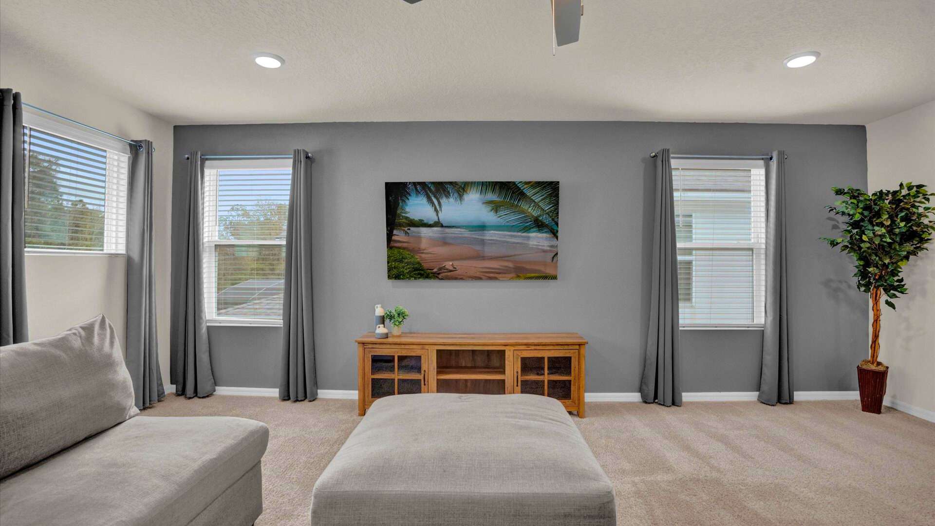 Upstairs lounge area with smart TV and natural light