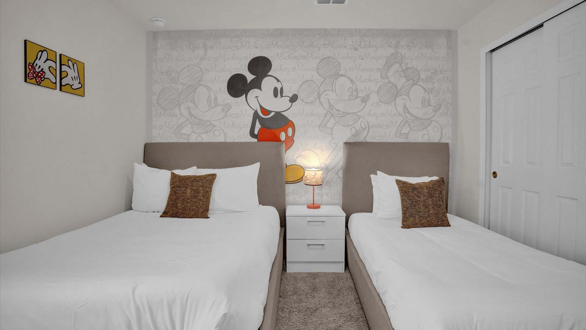 Mickey-Moused themed bedroom with a full and single bed