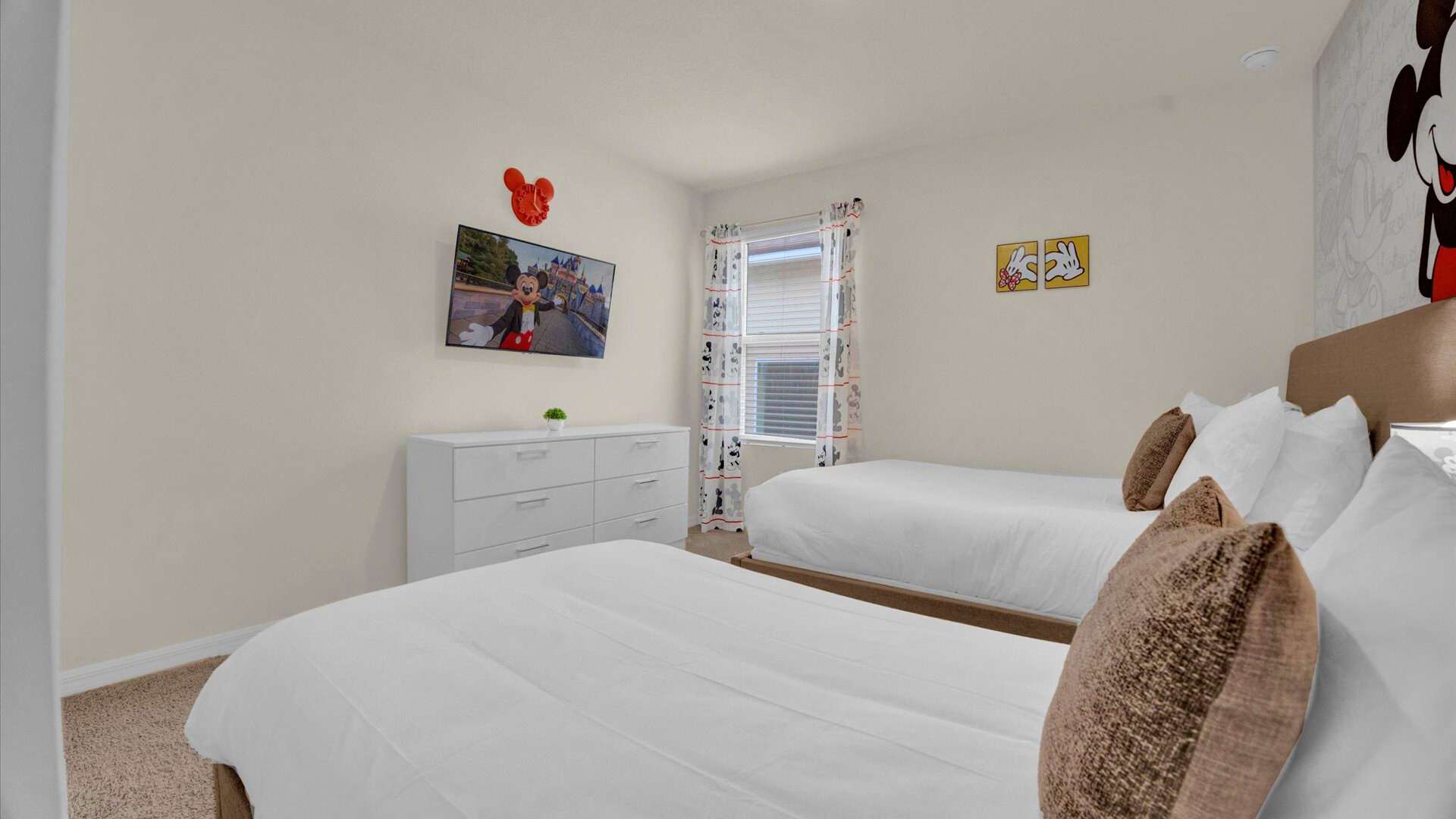 Mickey-Moused themed bedroom with a full and single bed