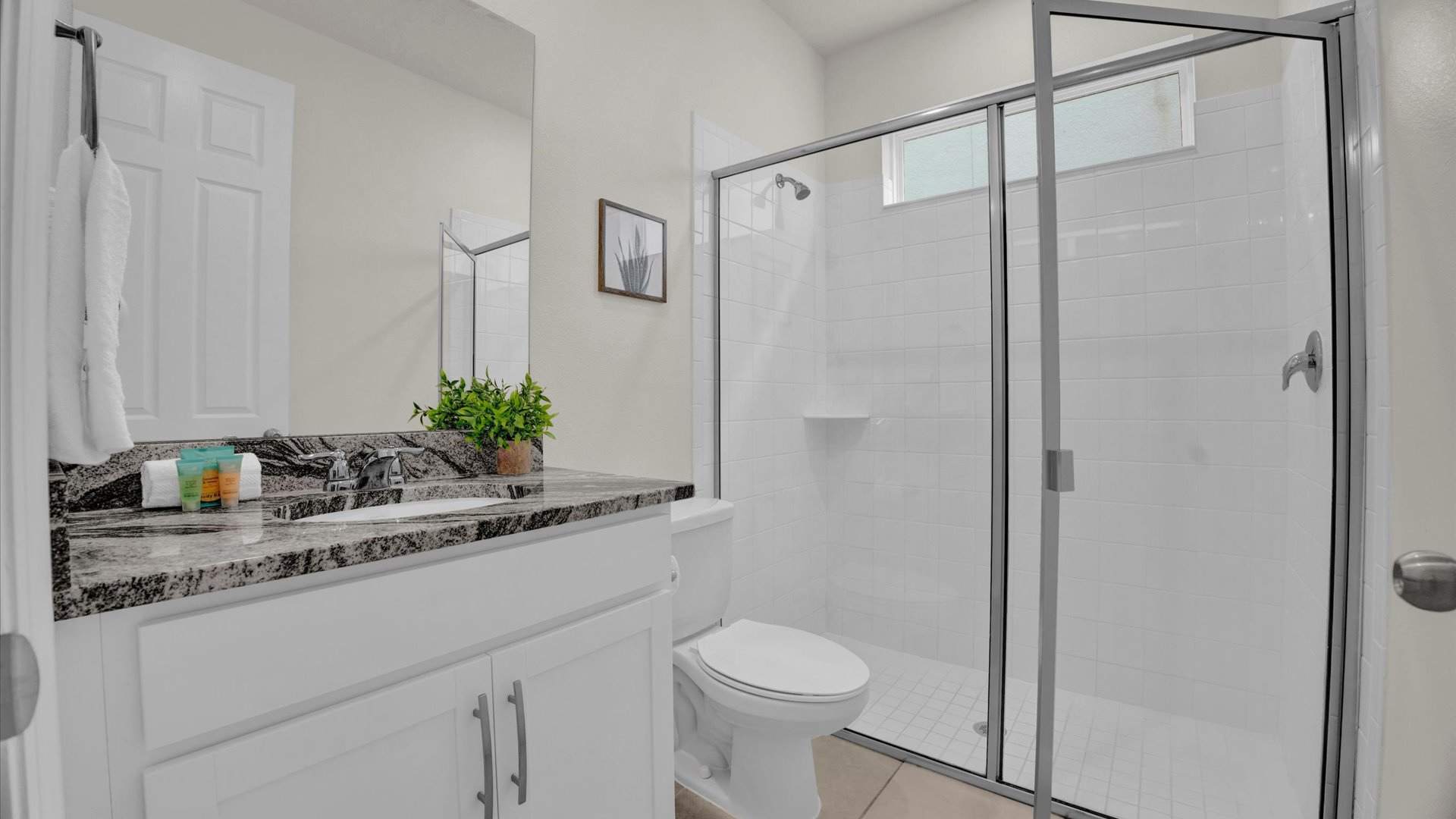 Full bathroom with vanity, shower ant toilet 