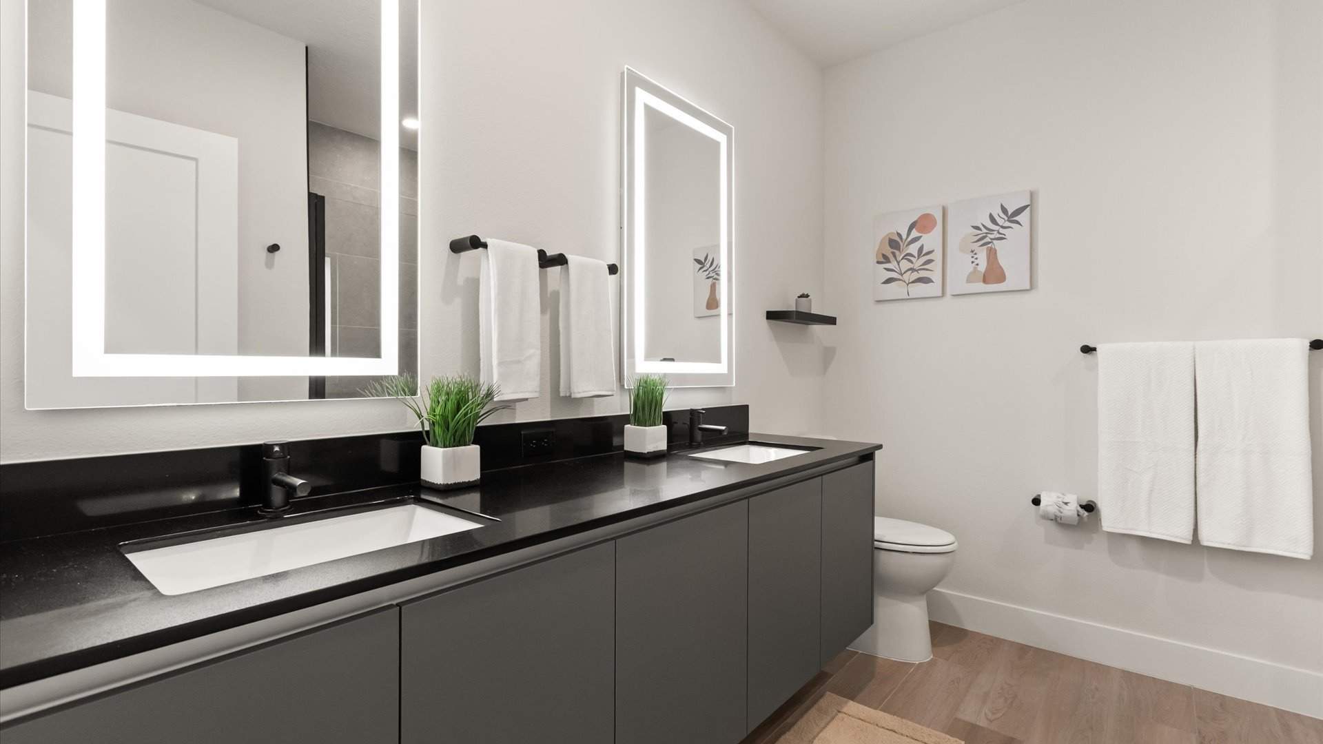 Spacious Contemporary en-suite bathroom with double vanity and LED mirrors