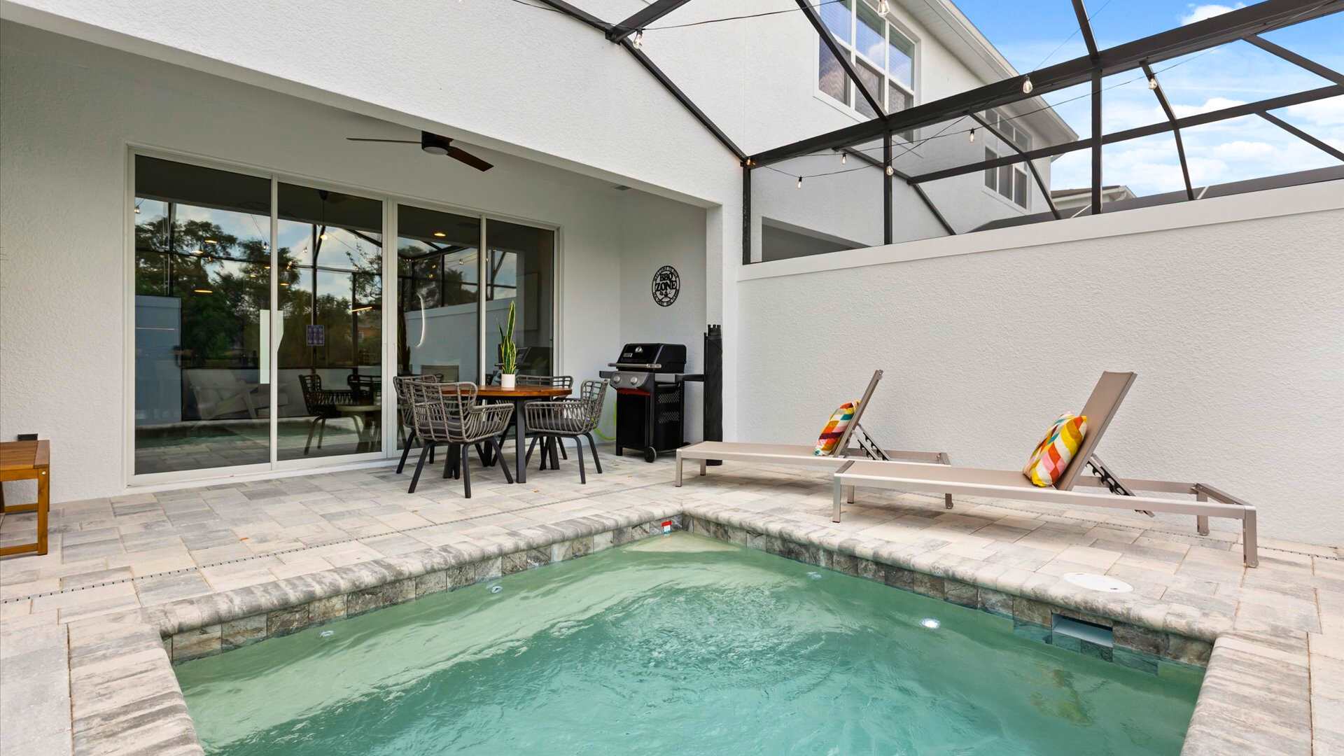 Refreshing private outdoor swimming pool with patio dining area