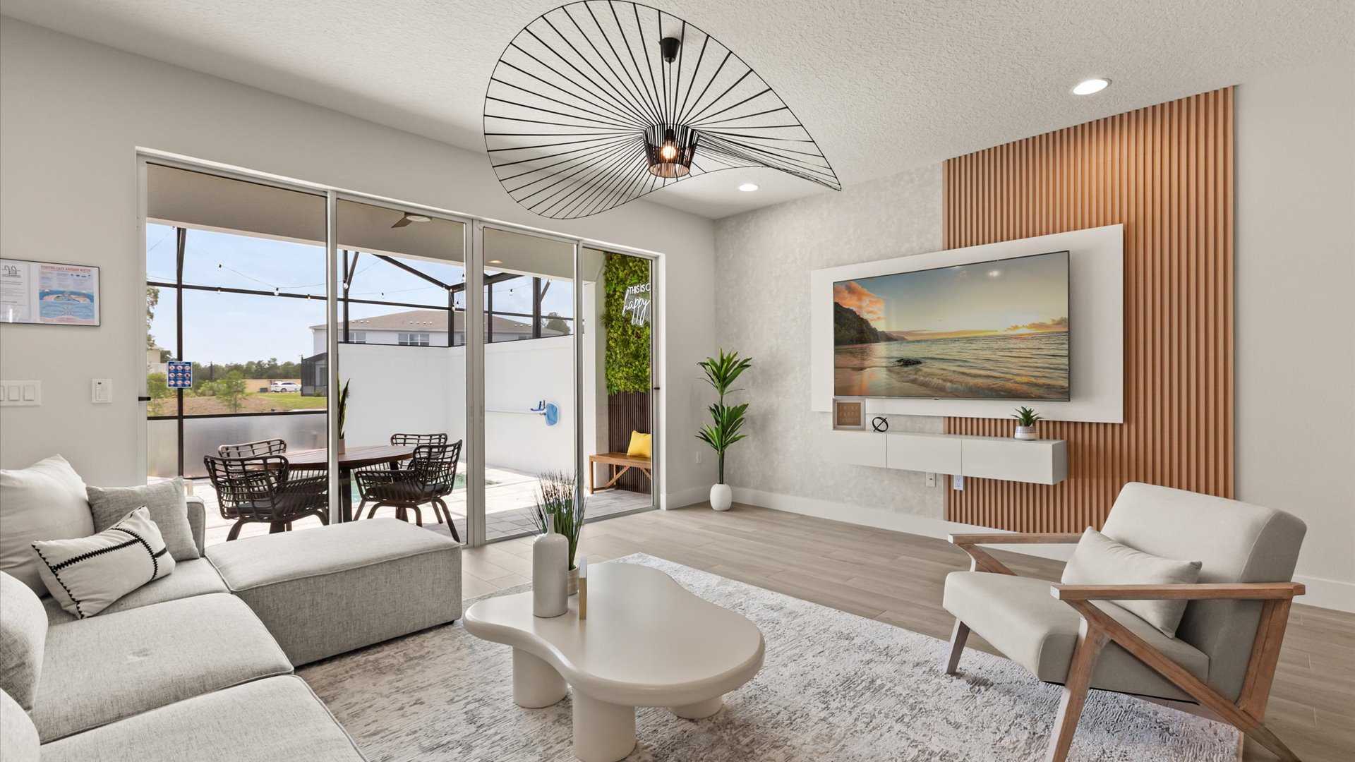 Stunning open-concept living area with modern furnishings with smart TV and direct patio access