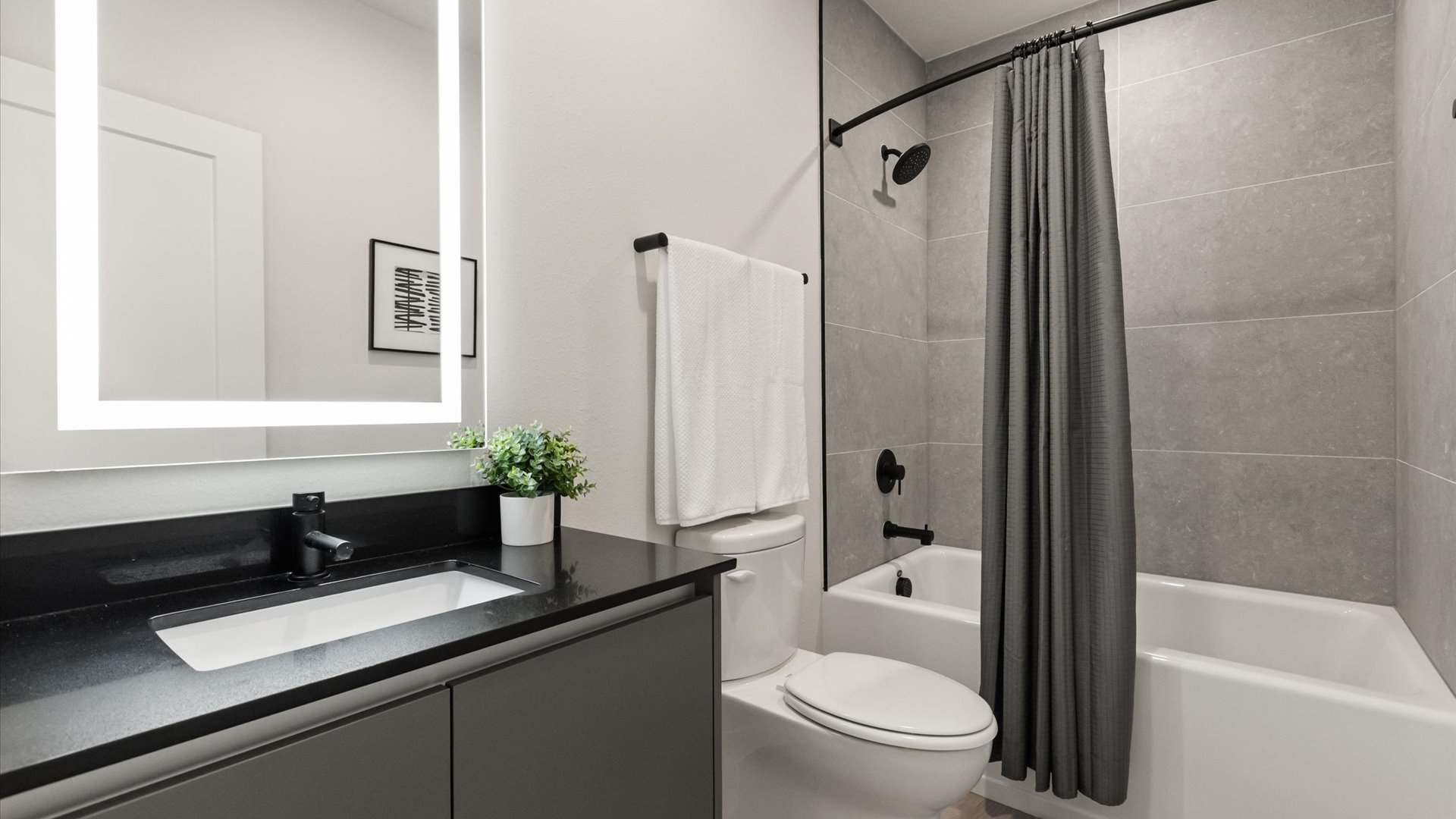 Stunning full bathroom with stylish vanity and integrated bathtub and shower