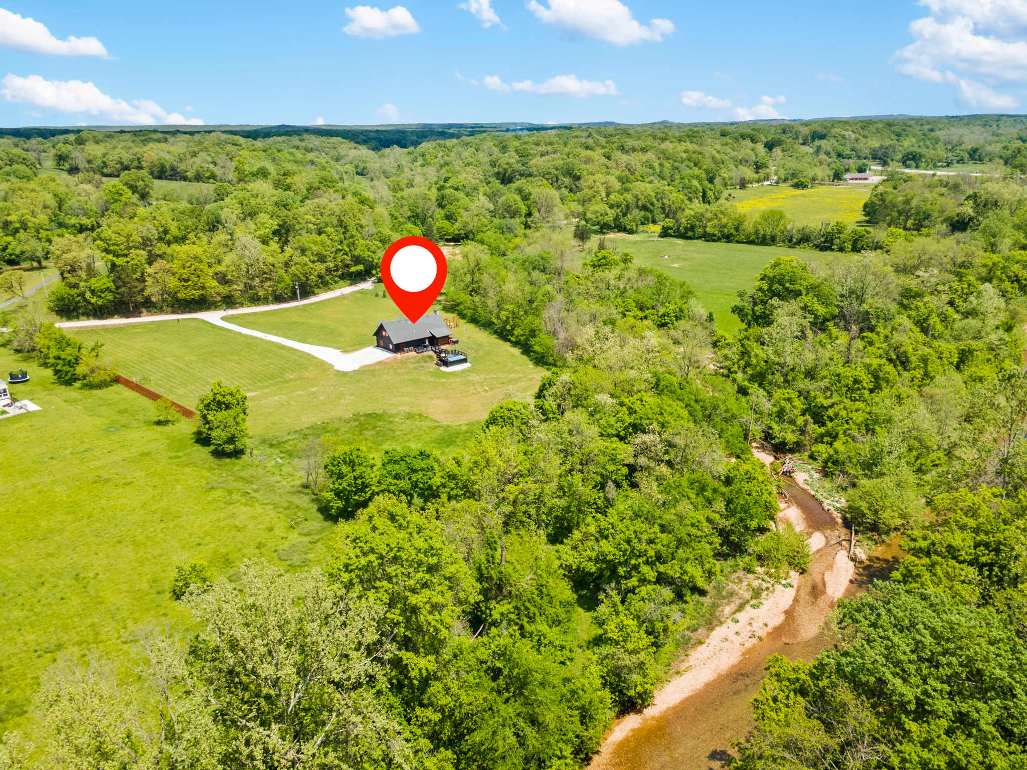 Five sprawling acres with direct creek access and minutes to Rogers, Bentonville, and Beaver Lake