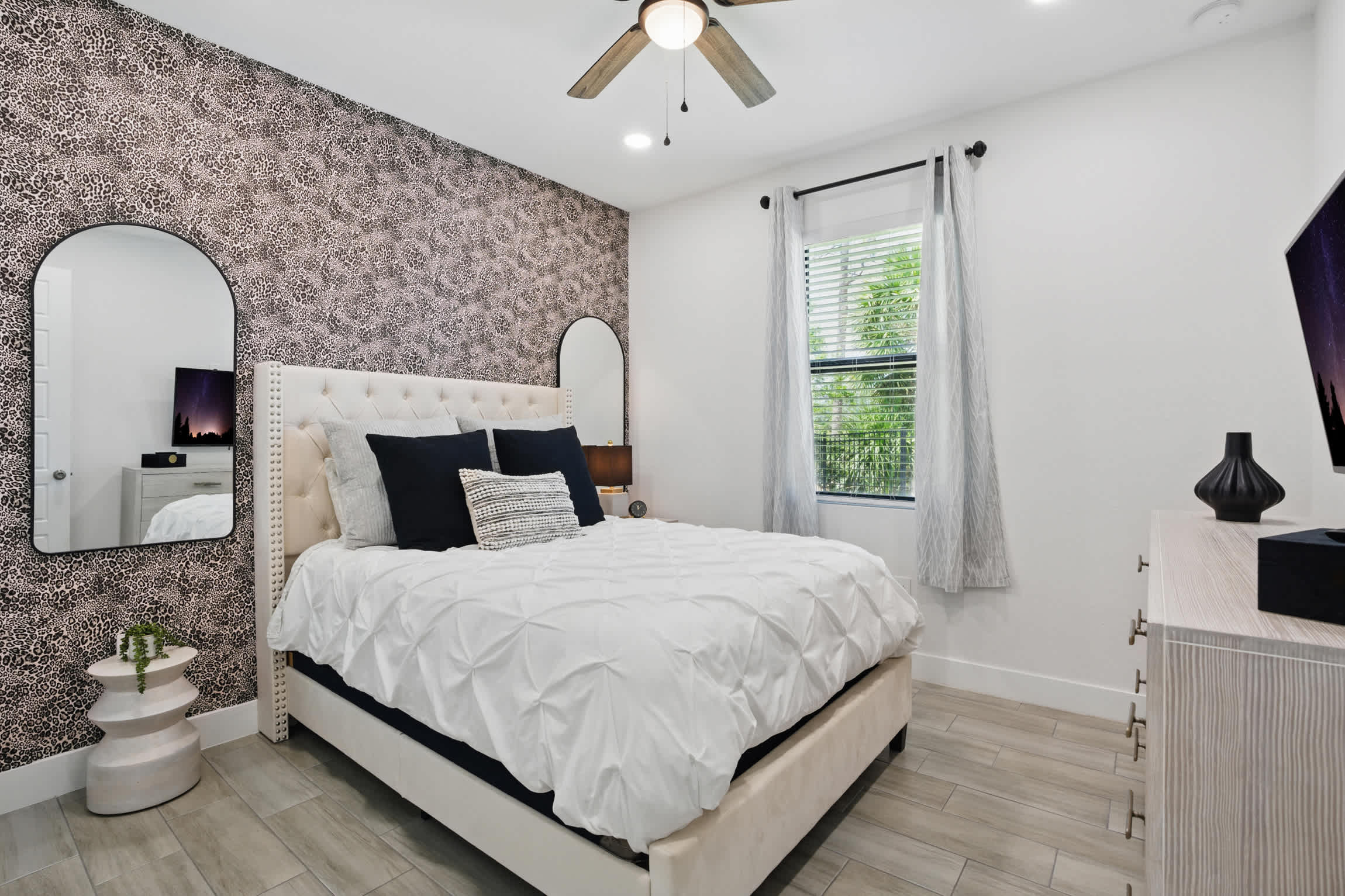 Bedroom #3 contains a queen bed and has views to the pool and backyard