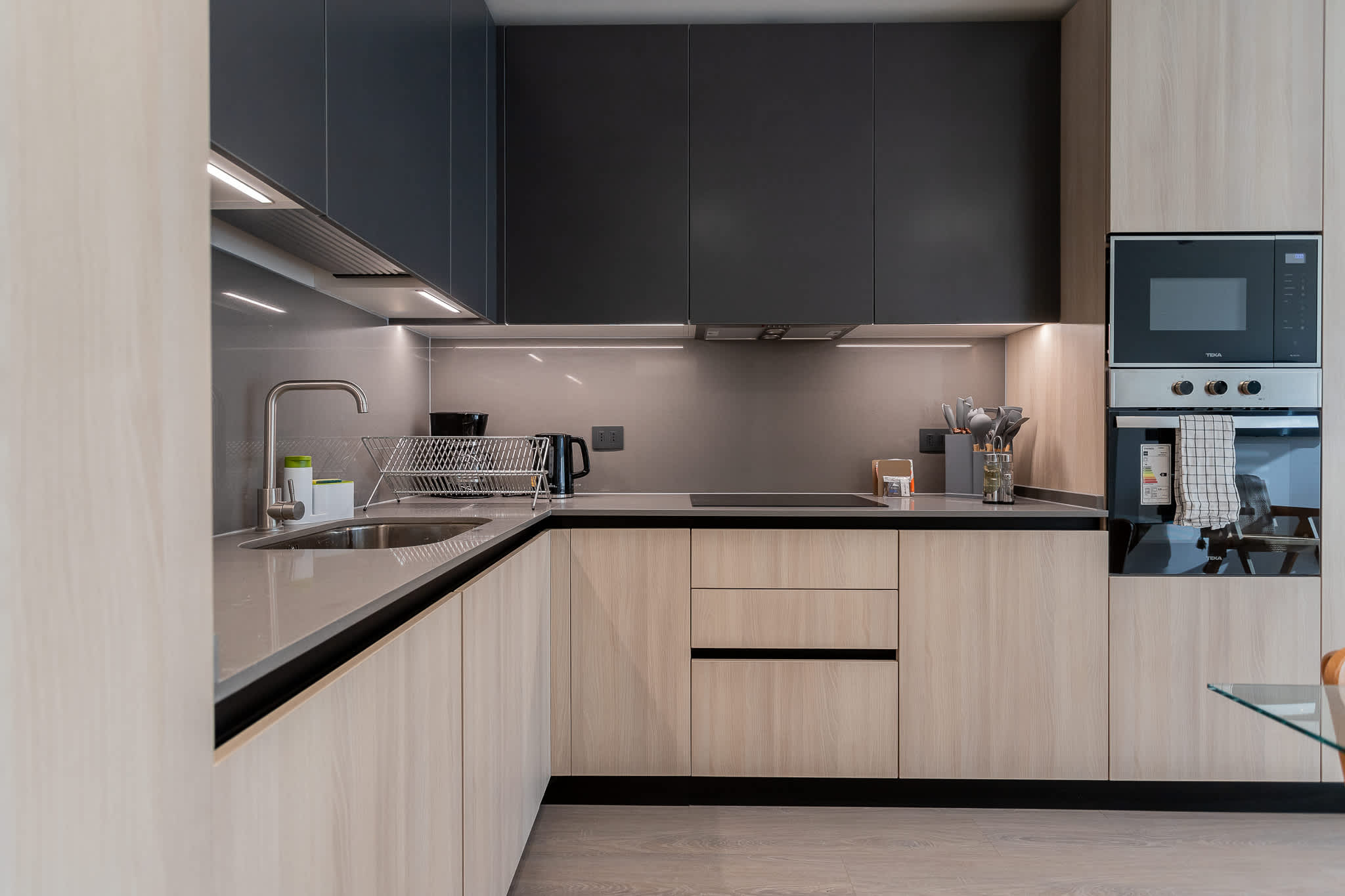 Experience culinary bliss in this sleek, modern kitchen, featuring high-end appliances and a stylish design perfect for your vacation getaway.