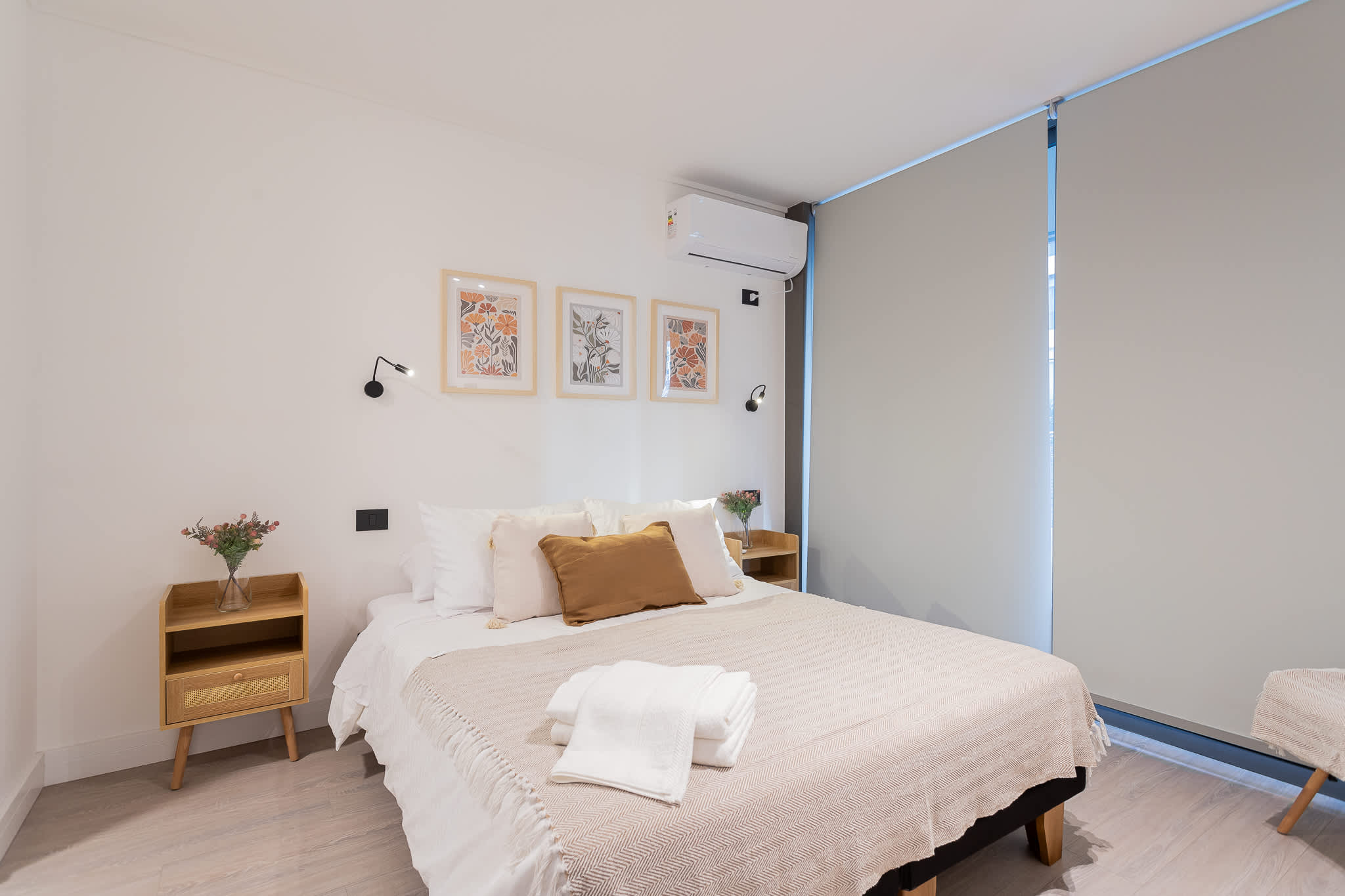 Relax in this cozy bedroom featuring stylish decor, comfortable bedding, and natural light for a peaceful stay.