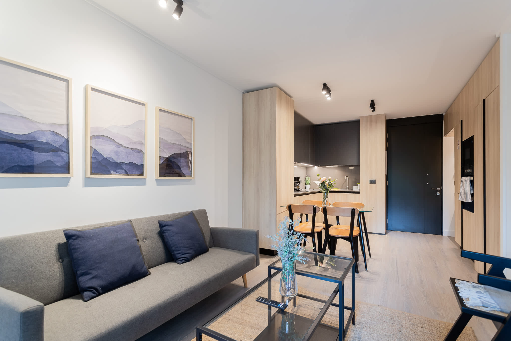 Stylish and modern living area with a cozy sofa, dining space, and contemporary decor, perfect for relaxation and gatherings.