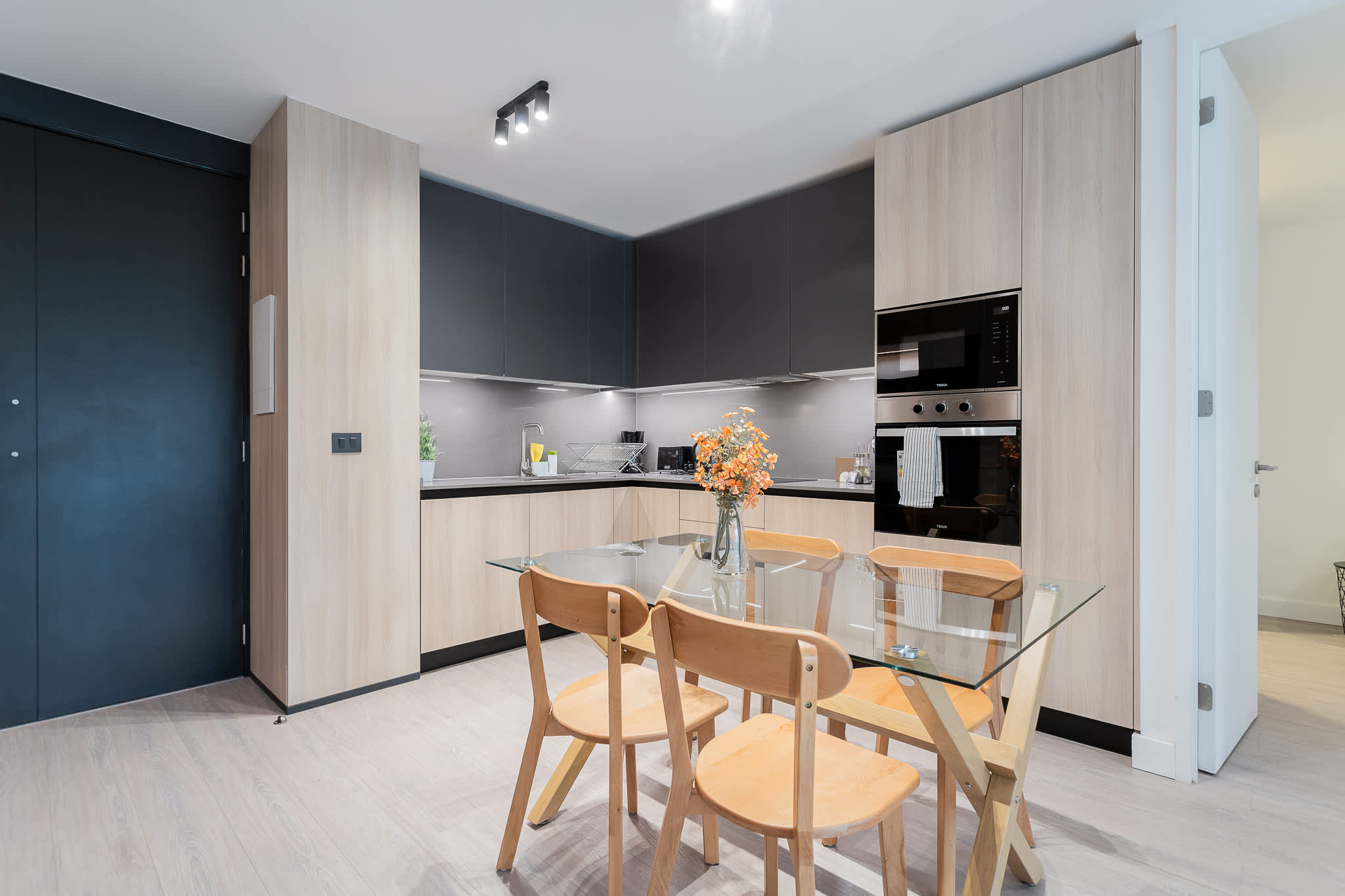 Experience a sleek, modern kitchen equipped with everything you need for a comfortable stay, perfect for cooking and dining together.