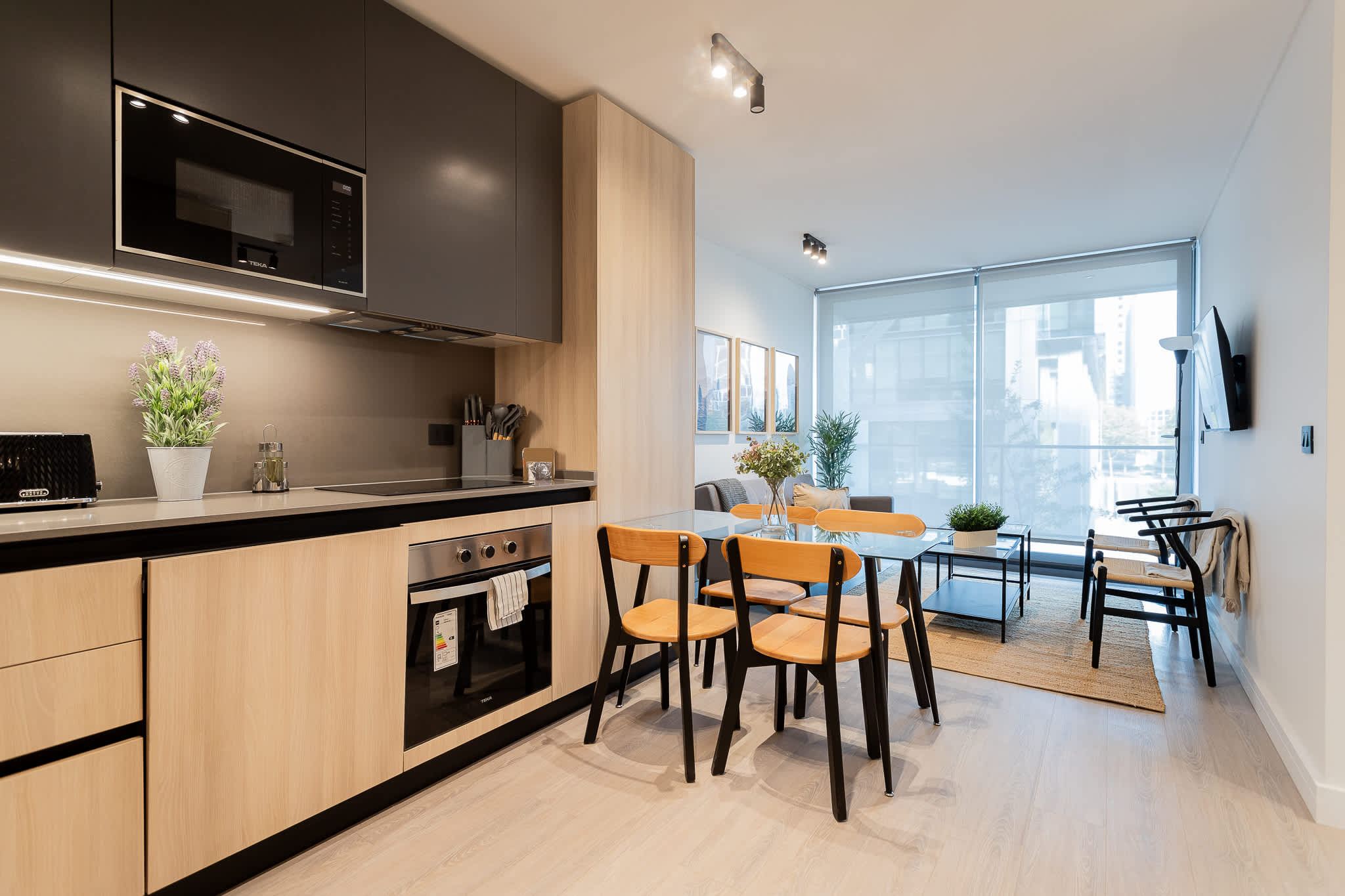 Experience modern living in this stylish kitchen, featuring sleek appliances and a bright dining area perfect for gatherings.