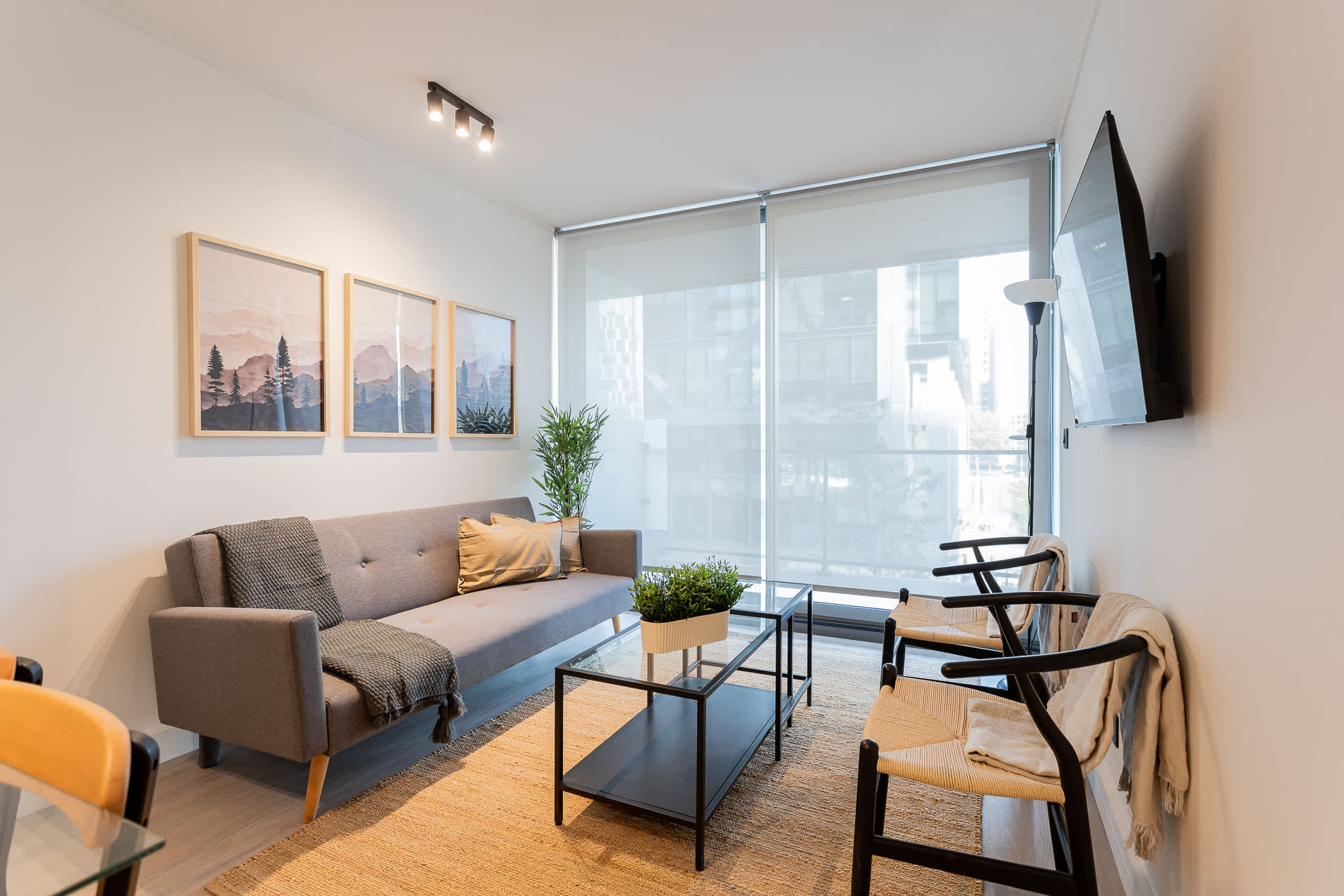 Bright and modern living room with stylish decor, perfect for relaxation and enjoying natural light.