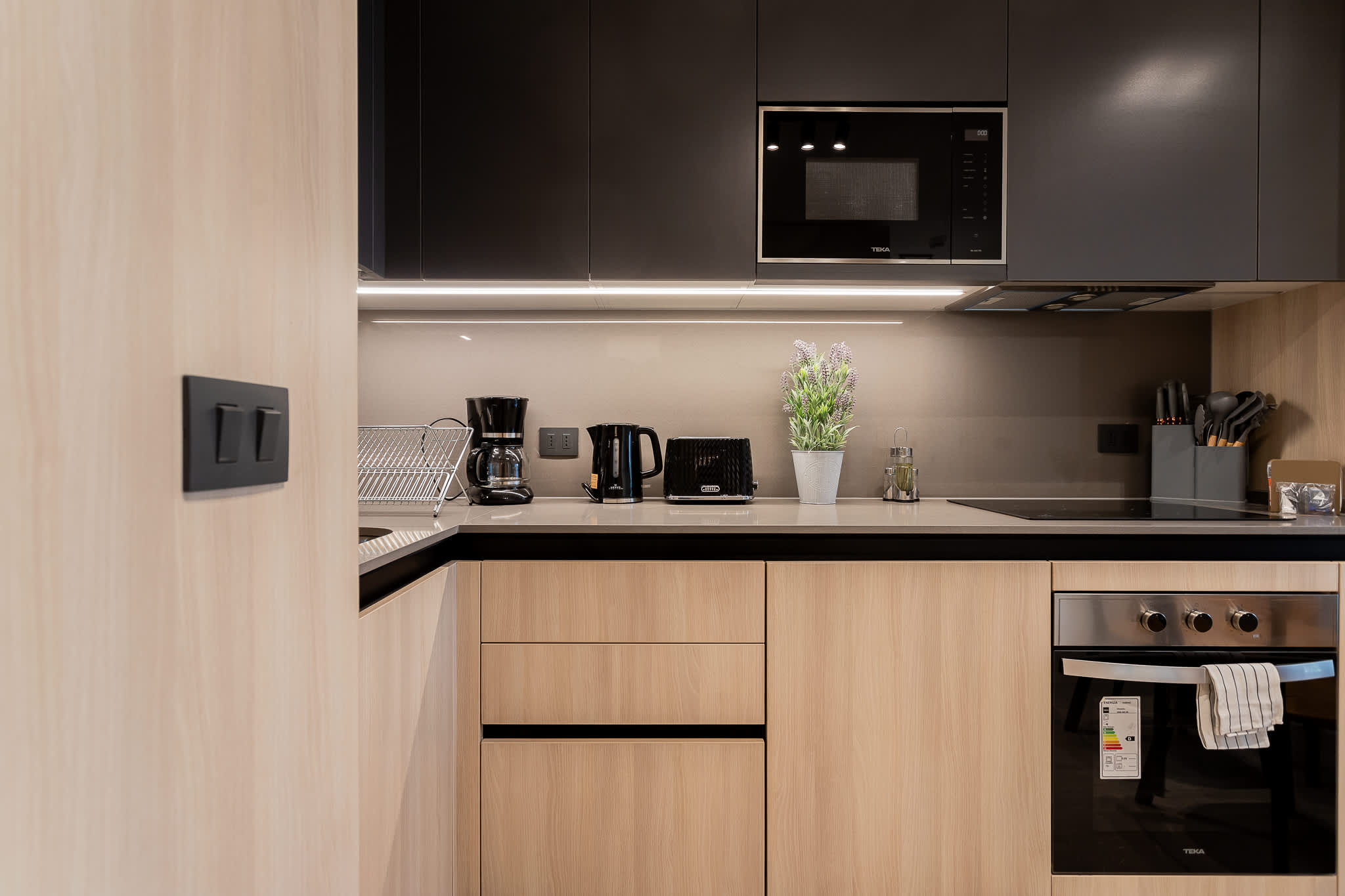 Experience a sleek and modern kitchen equipped with all essentials, perfect for culinary adventures during your stay!