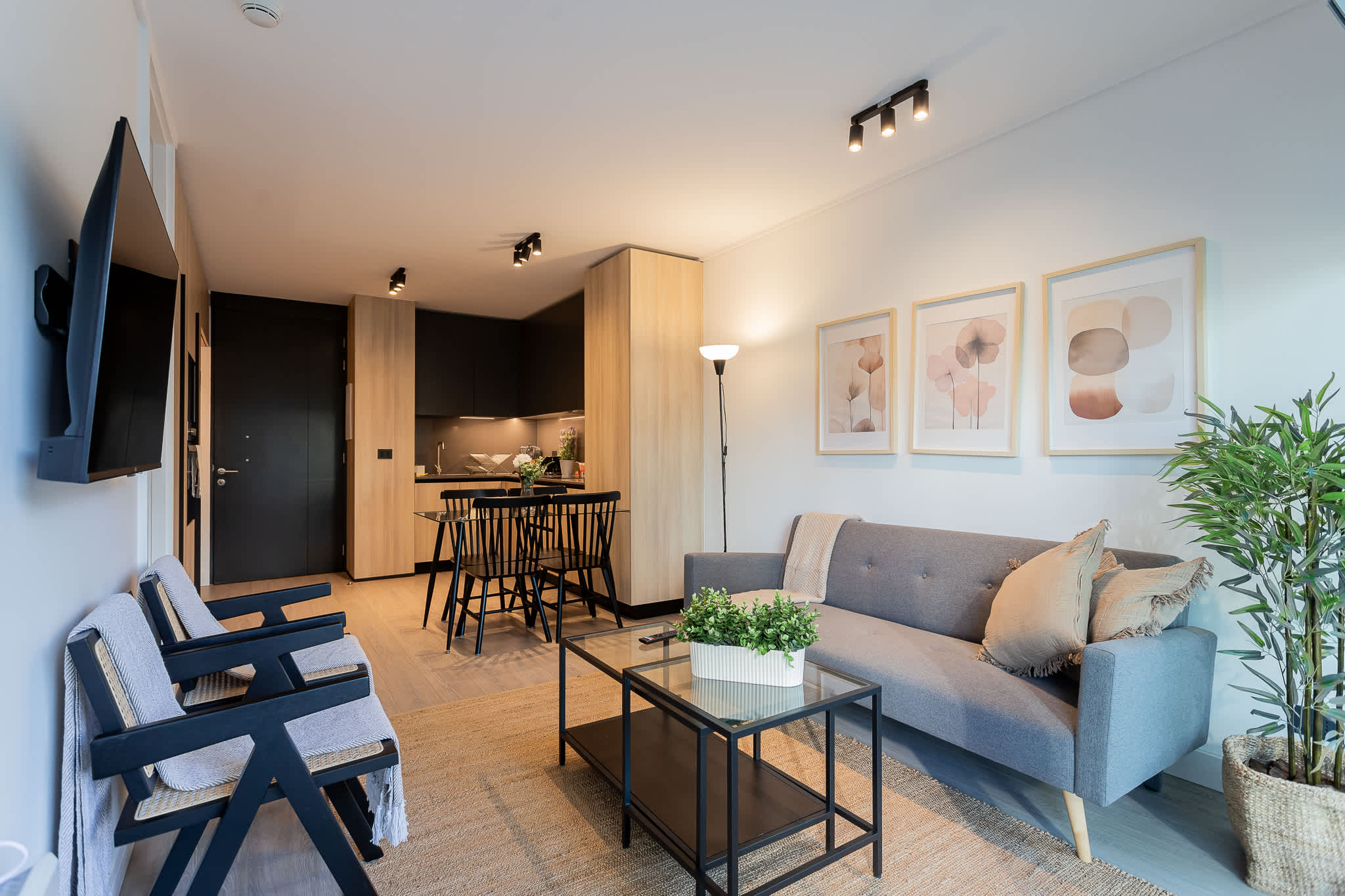 Stylish and cozy living area with modern furnishings and a well-equipped kitchen, perfect for relaxation and dining.