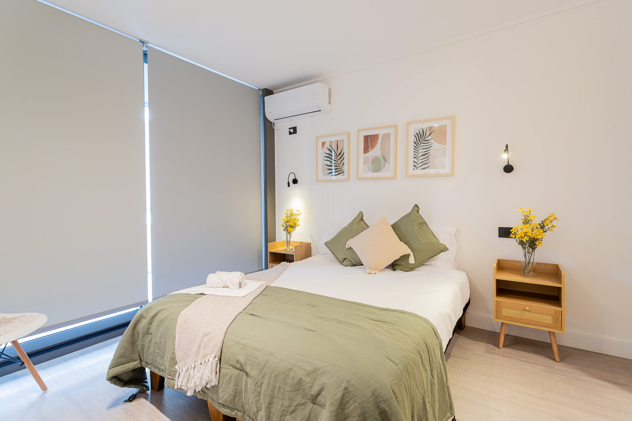 Relax in this serene bedroom with modern decor and cozy bedding, perfect for unwinding after a day of exploring.