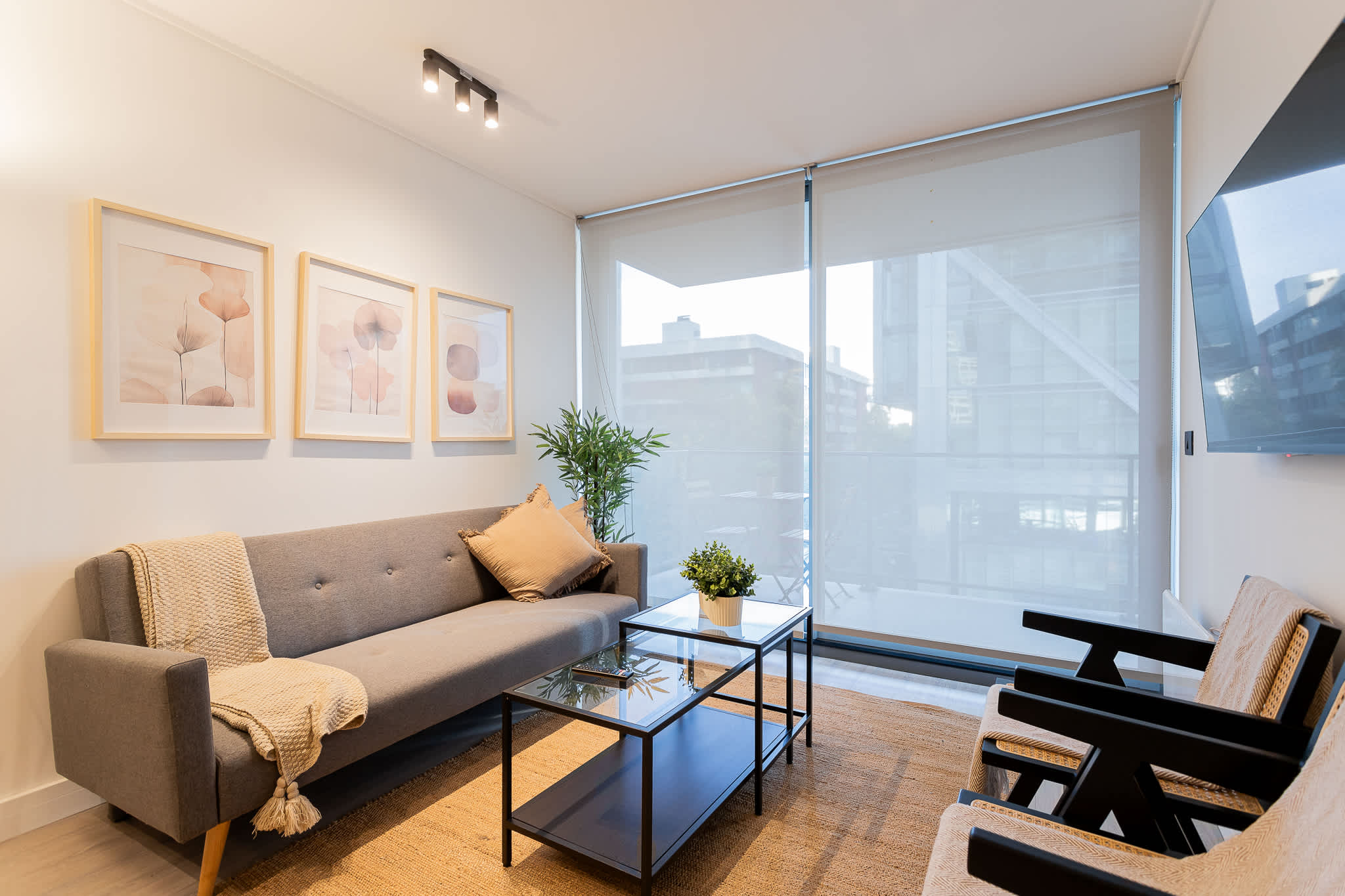 Cozy living area with modern decor and ample natural light, perfect for relaxation.
