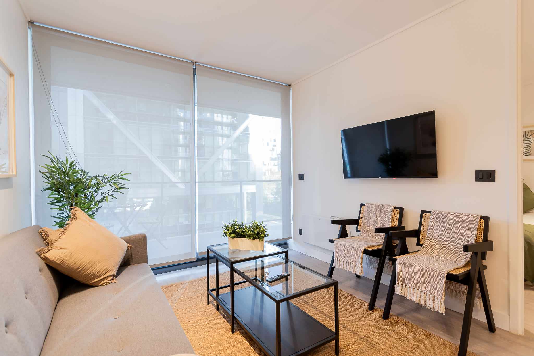 Cozy living room with modern decor and ample natural light, perfect for relaxation and entertainment.