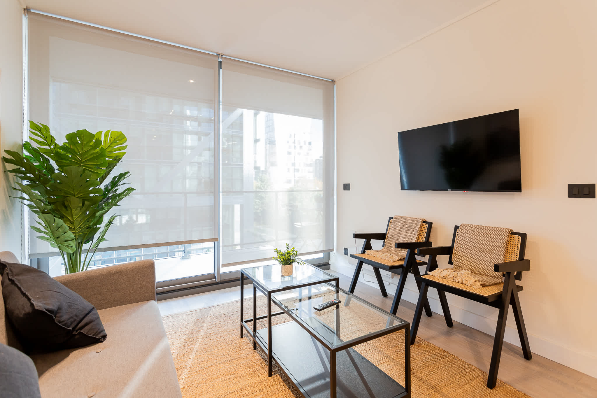 Bright and modern living room with stylish furnishings and a cozy atmosphere, perfect for relaxation after a day of exploring.