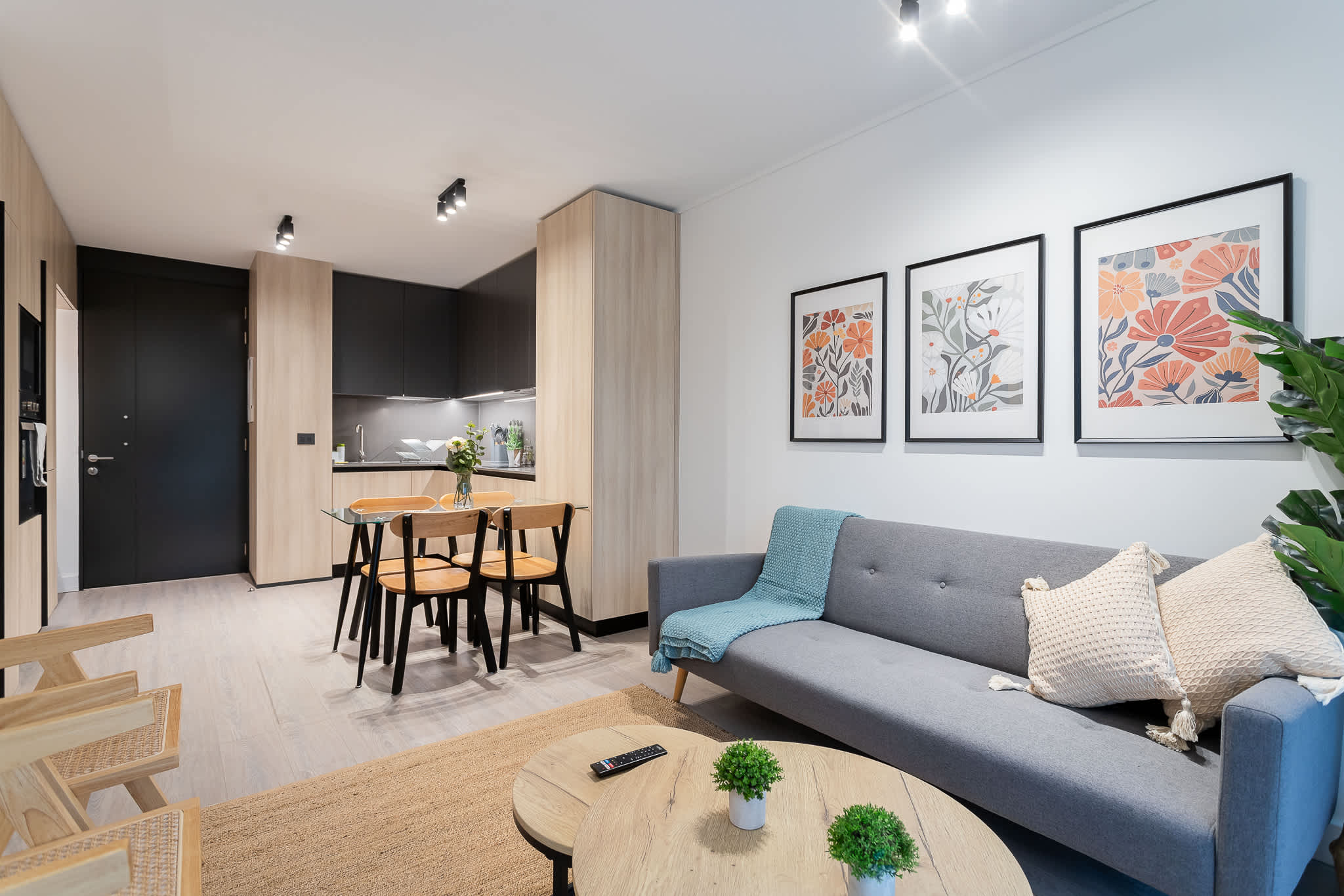 Relax in this chic living space with modern decor, a cozy sofa, and a stylish dining area perfect for intimate meals.