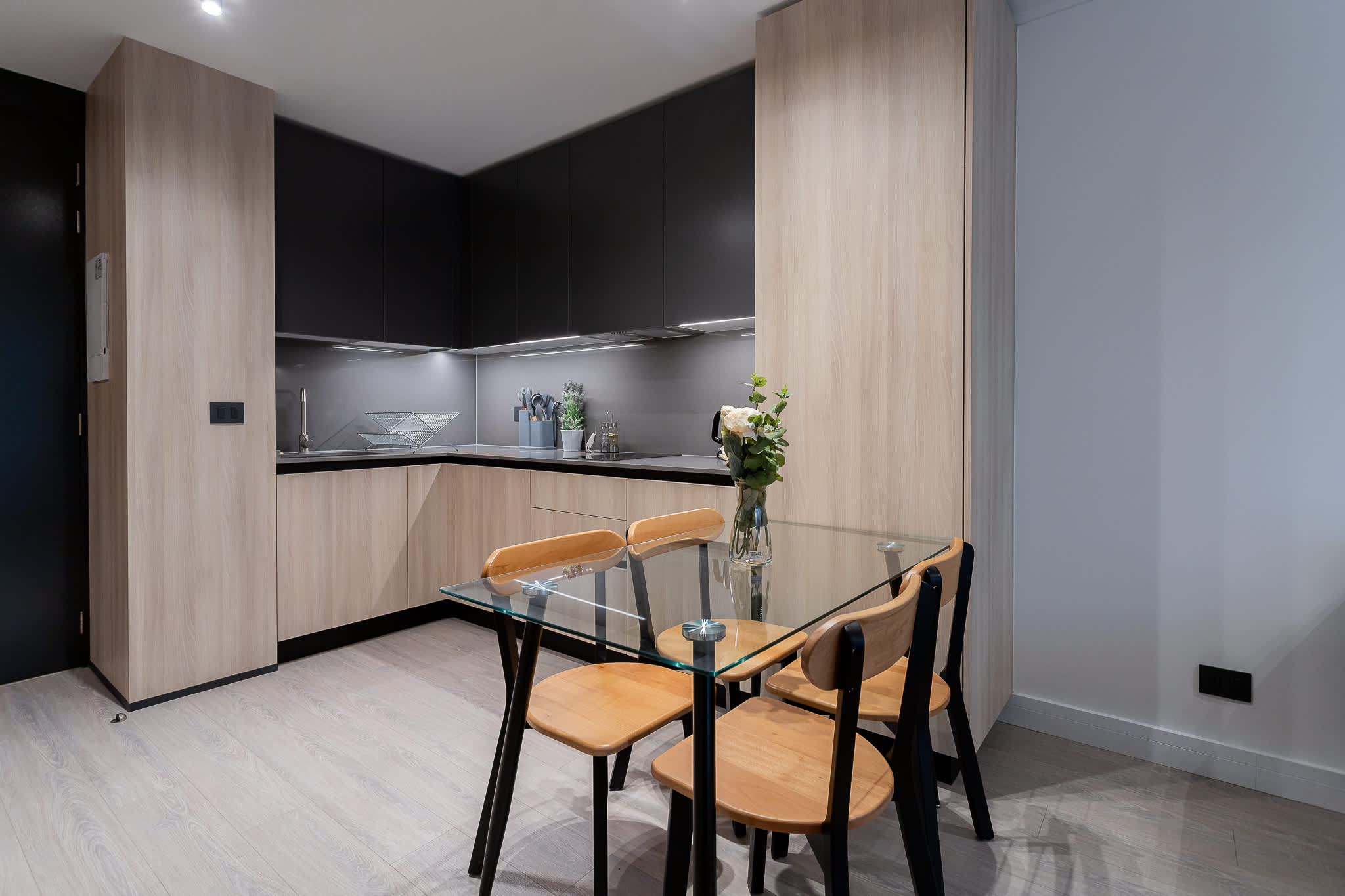 Enjoy a meal in this chic kitchen with modern cabinetry and a cozy dining area, perfect for intimate gatherings.