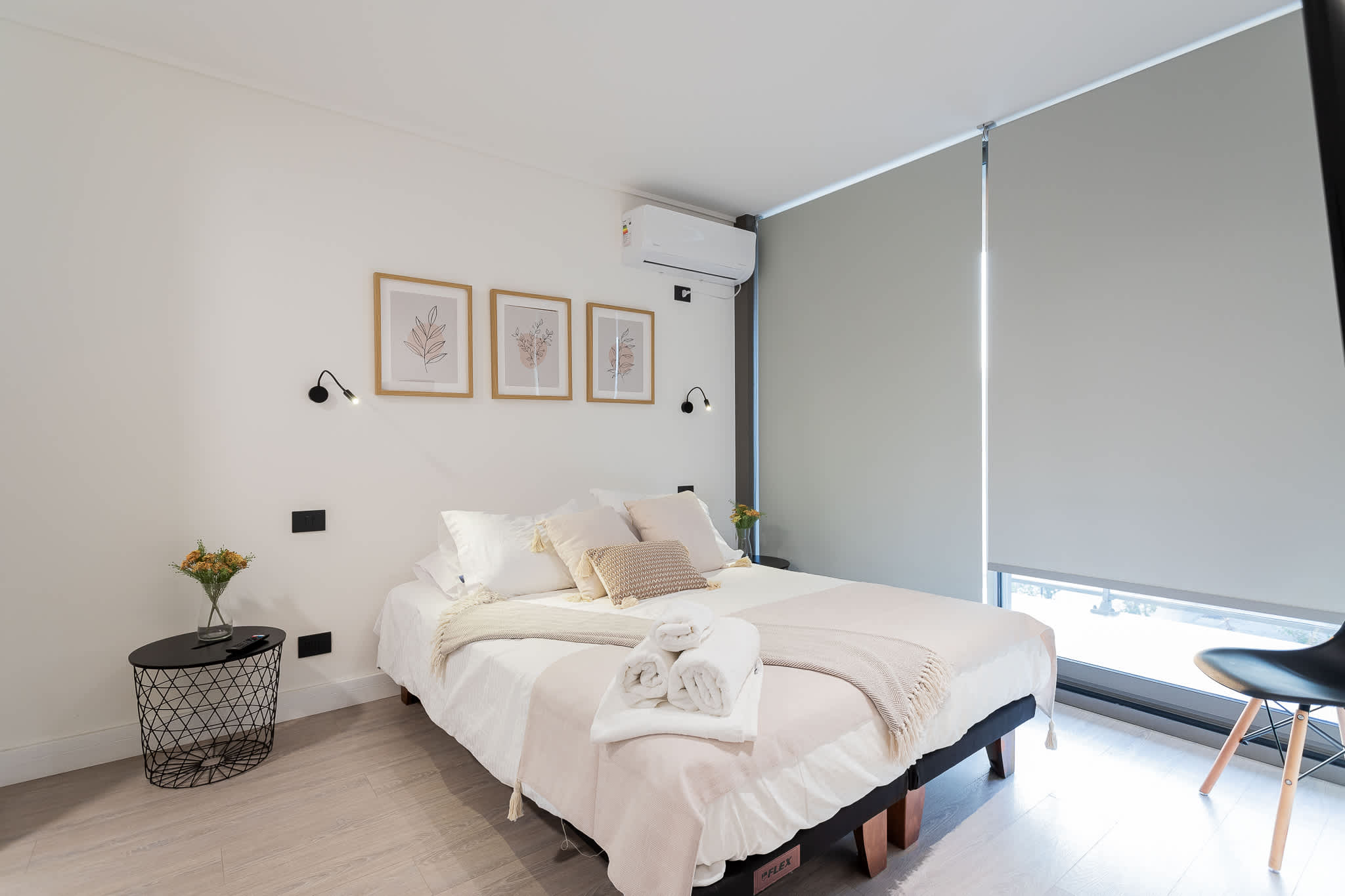 Experience tranquility in this modern bedroom, featuring a cozy queen bed and stylish decor, perfect for a restful getaway.