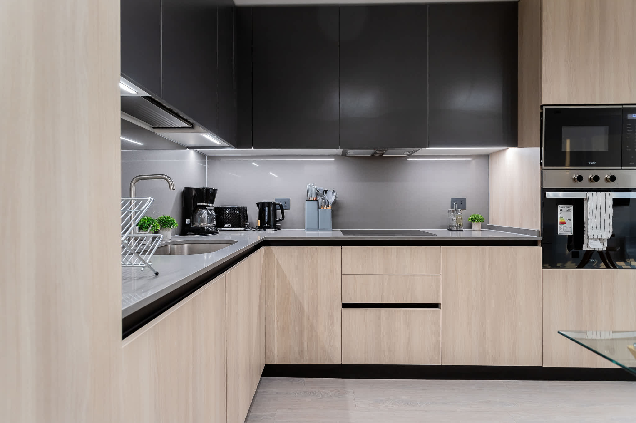 Experience culinary bliss in this sleek, modern kitchen equipped with top-notch appliances and a minimalist design for your cooking adventures.