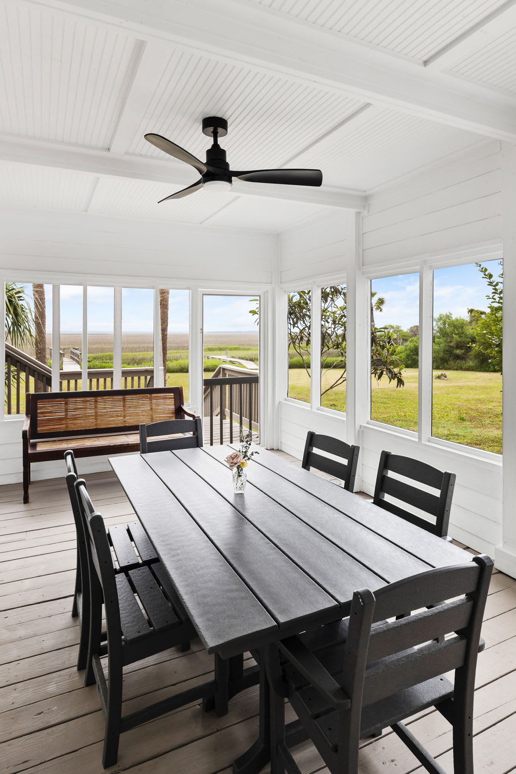 Additional dining area in the screened-in porch with beautiful views! 