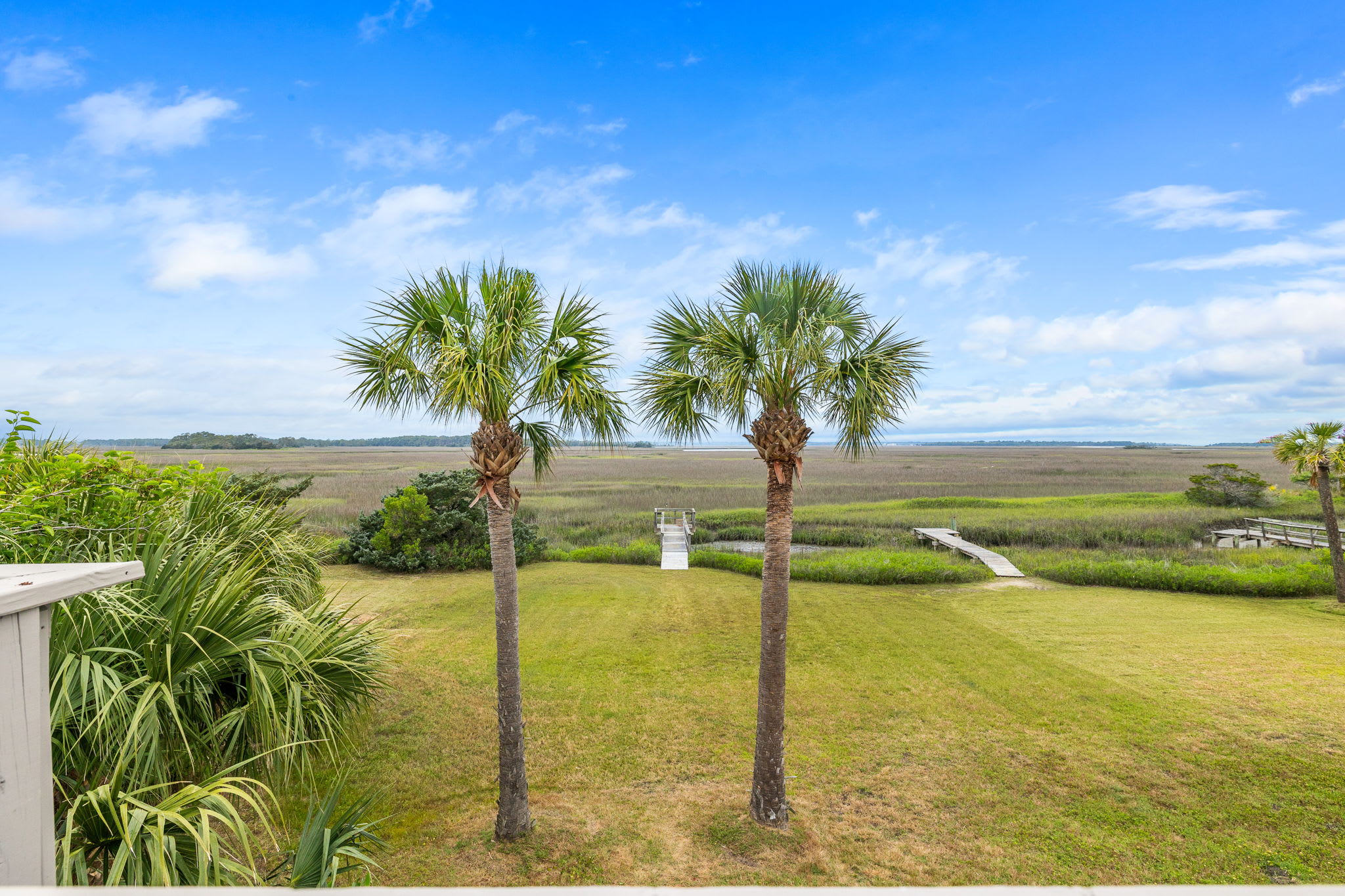 Large backyard that leads to the private dock on Folly Creek!