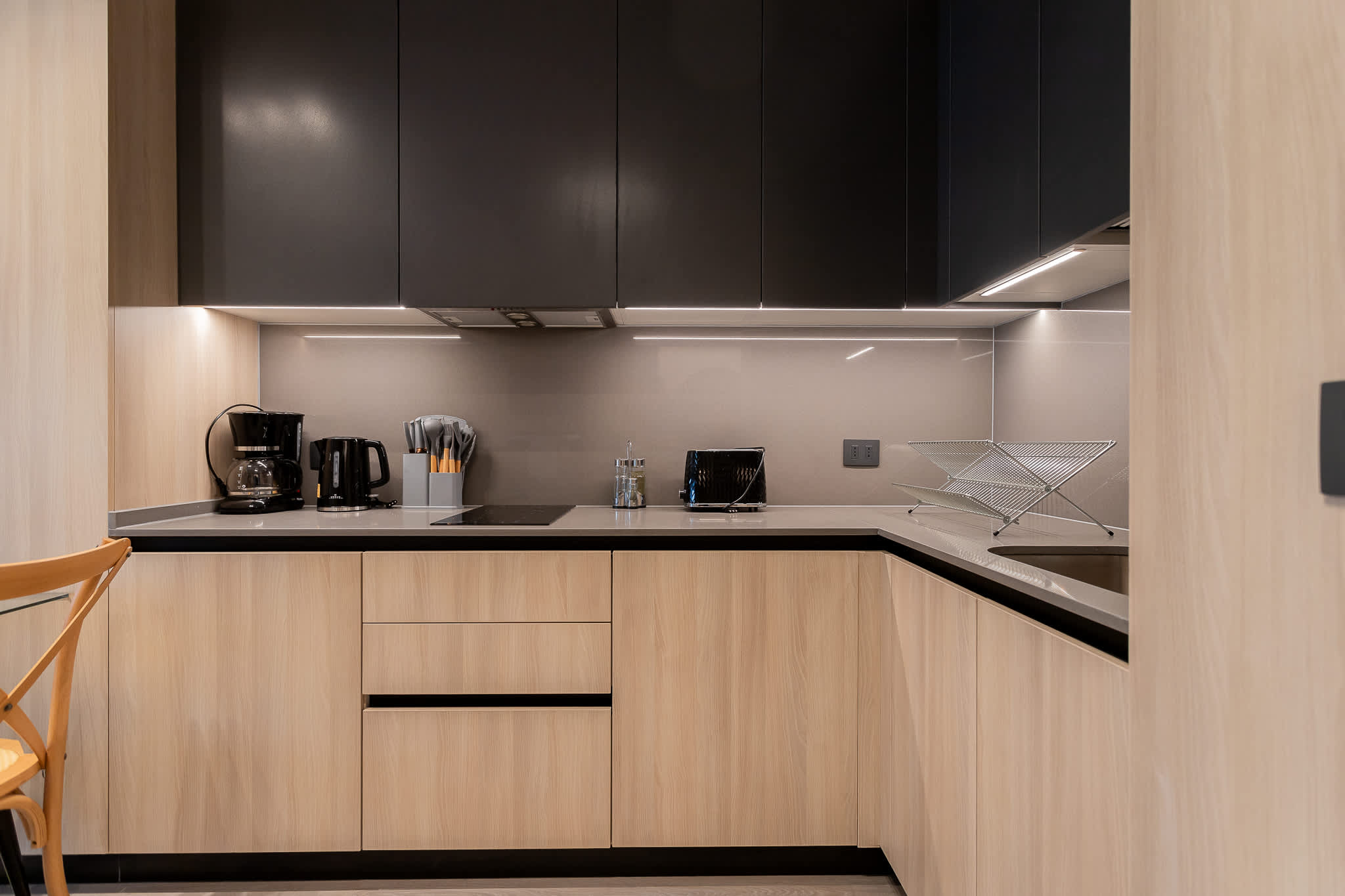 Experience a sleek and modern kitchen, equipped with essential appliances and a stylish design for your culinary adventures.
