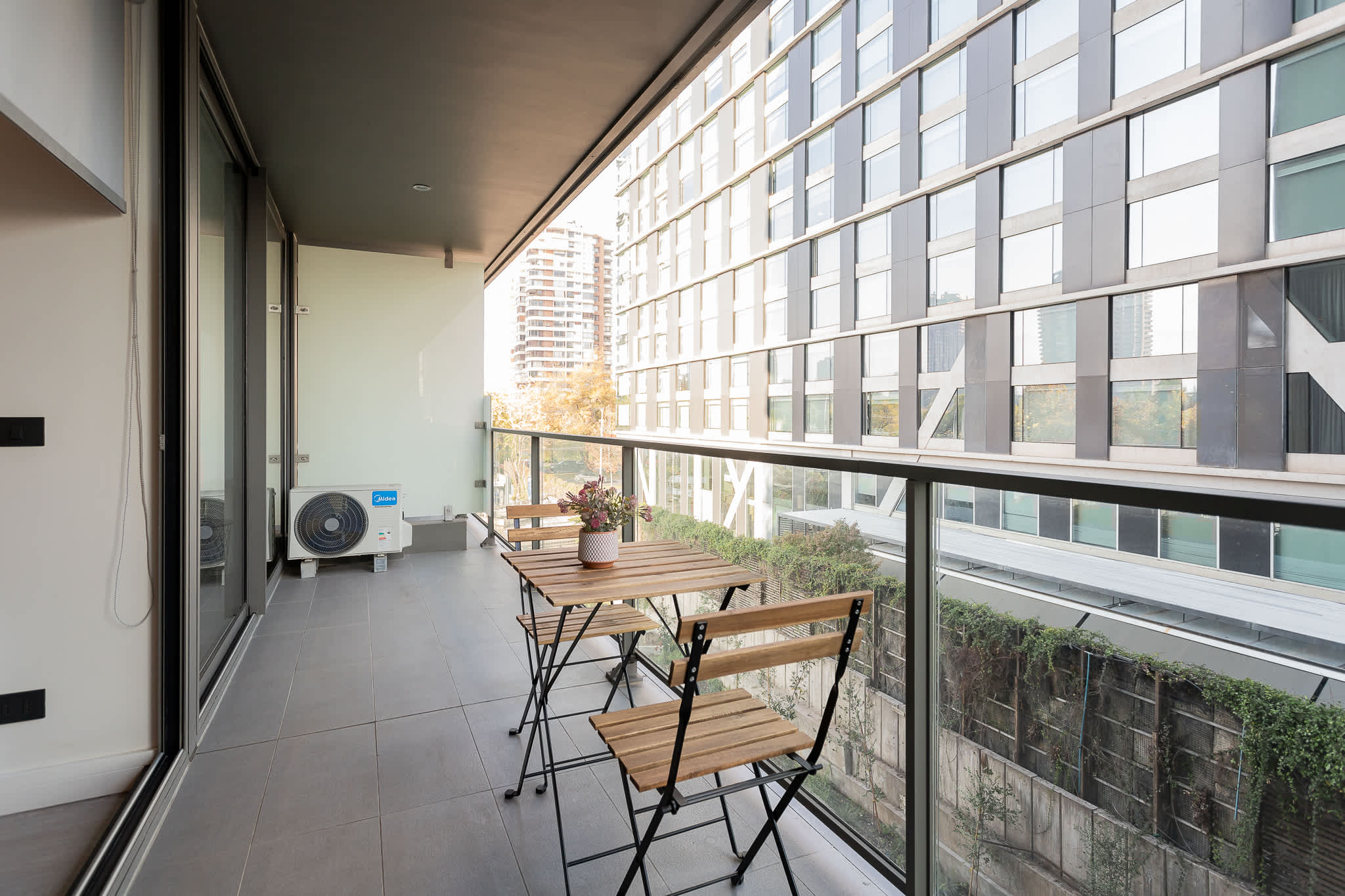 Enjoy a cozy balcony retreat with city views, perfect for morning coffee or evening relaxation.
