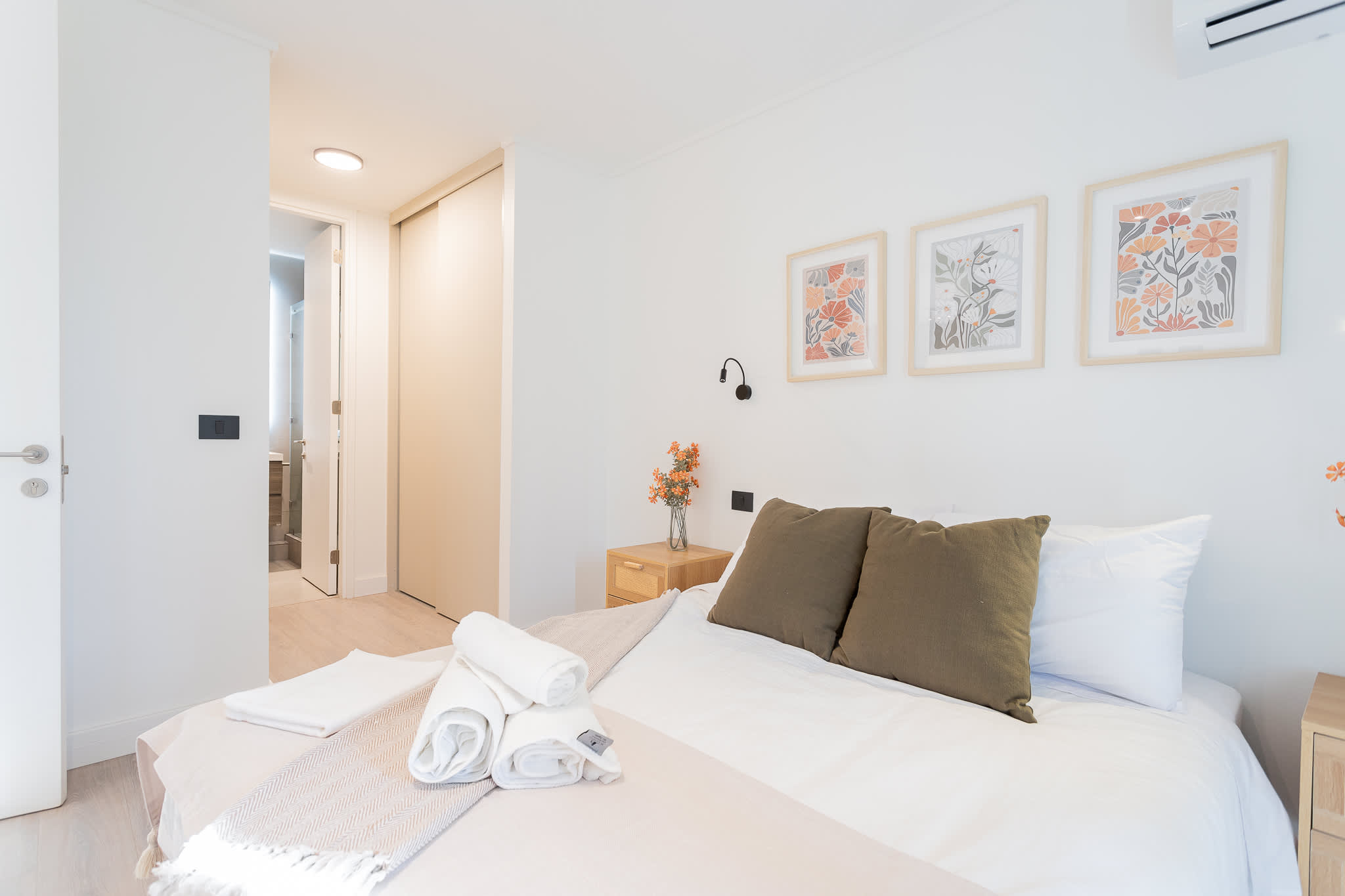 Experience tranquility in this beautifully designed bedroom, featuring cozy bedding and charming decor for a restful stay.