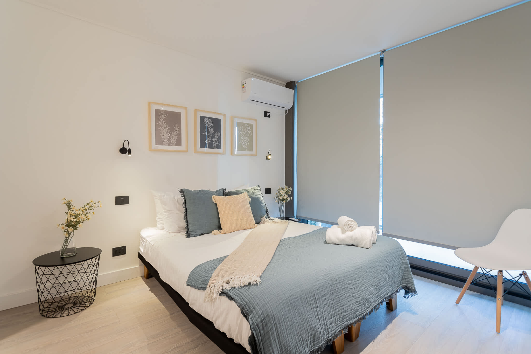 Relax in this cozy bedroom with stylish decor and ample natural light, perfect for unwinding after a day of exploring.